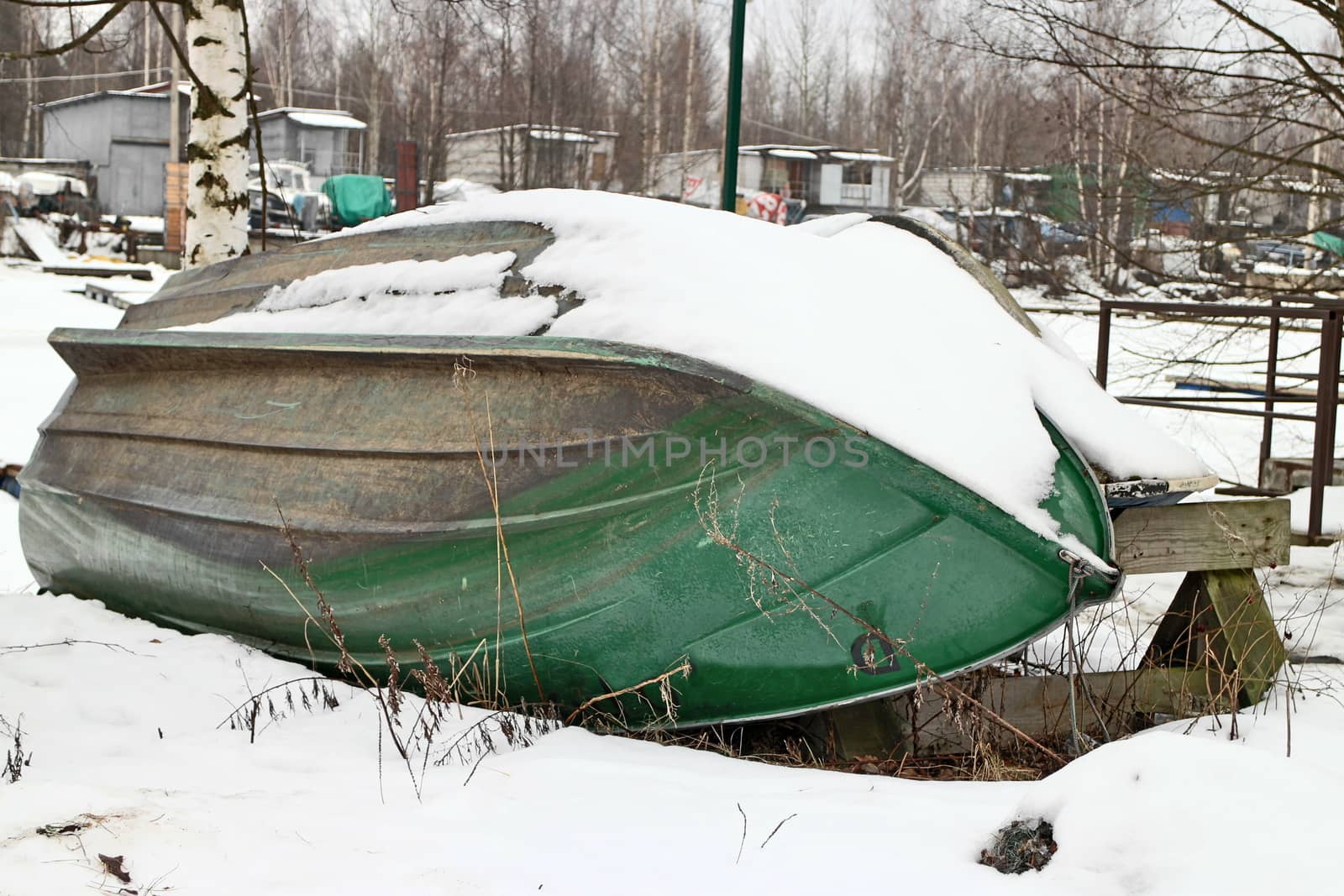 old rowing boat laying on the shore inverted upside down