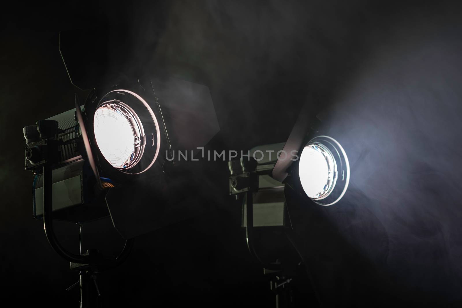 Two studio lights shining through the smoke from smoke machine.