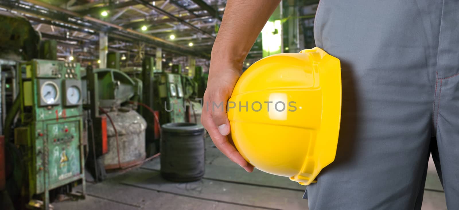 Worker with safety helmet at industrial factory