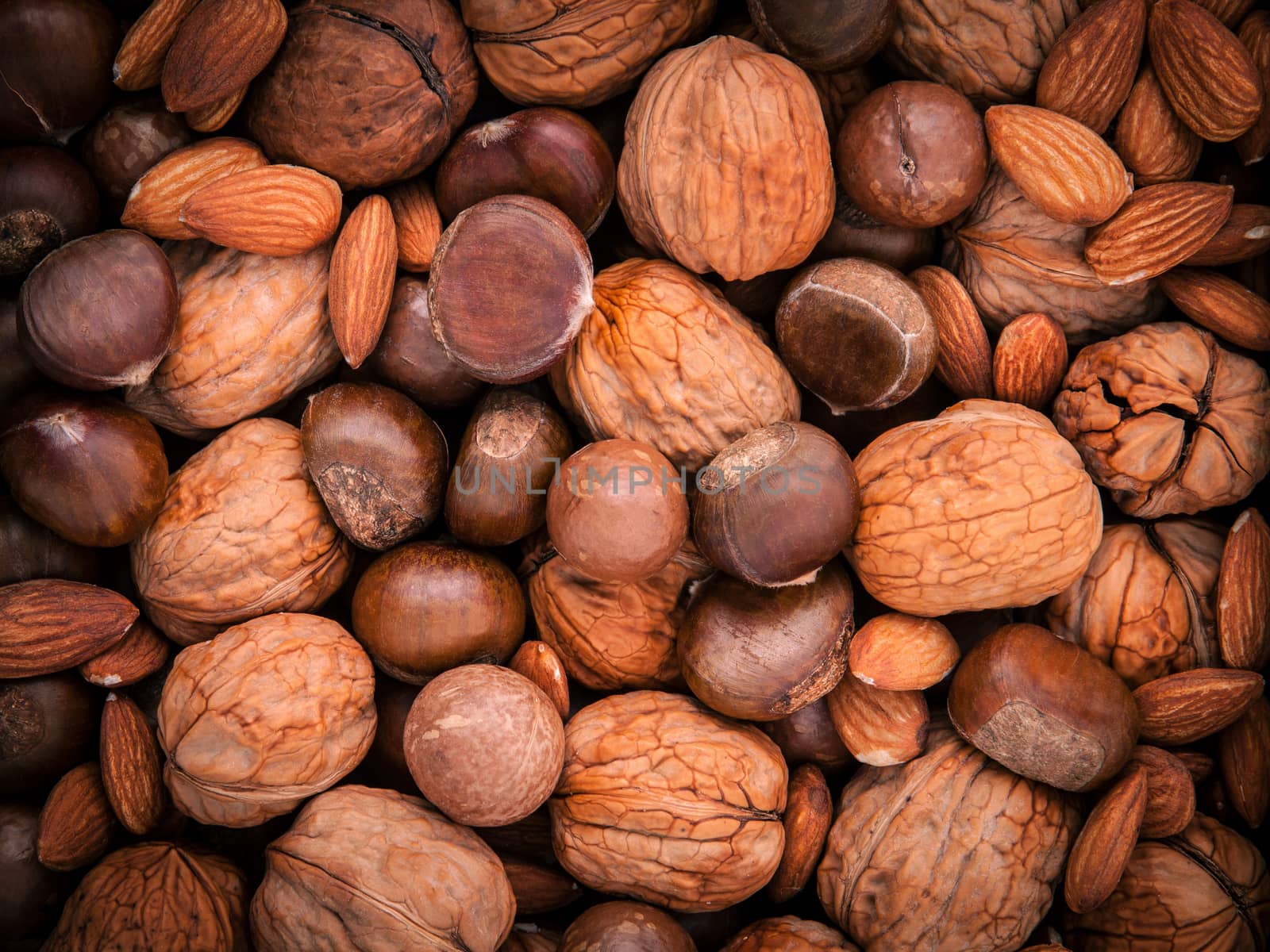 Background from different kinds of nuts in shells ,cashew, almond, walnut, hazelnut, pistachio, hazelnuts, pecan and  macadamia.