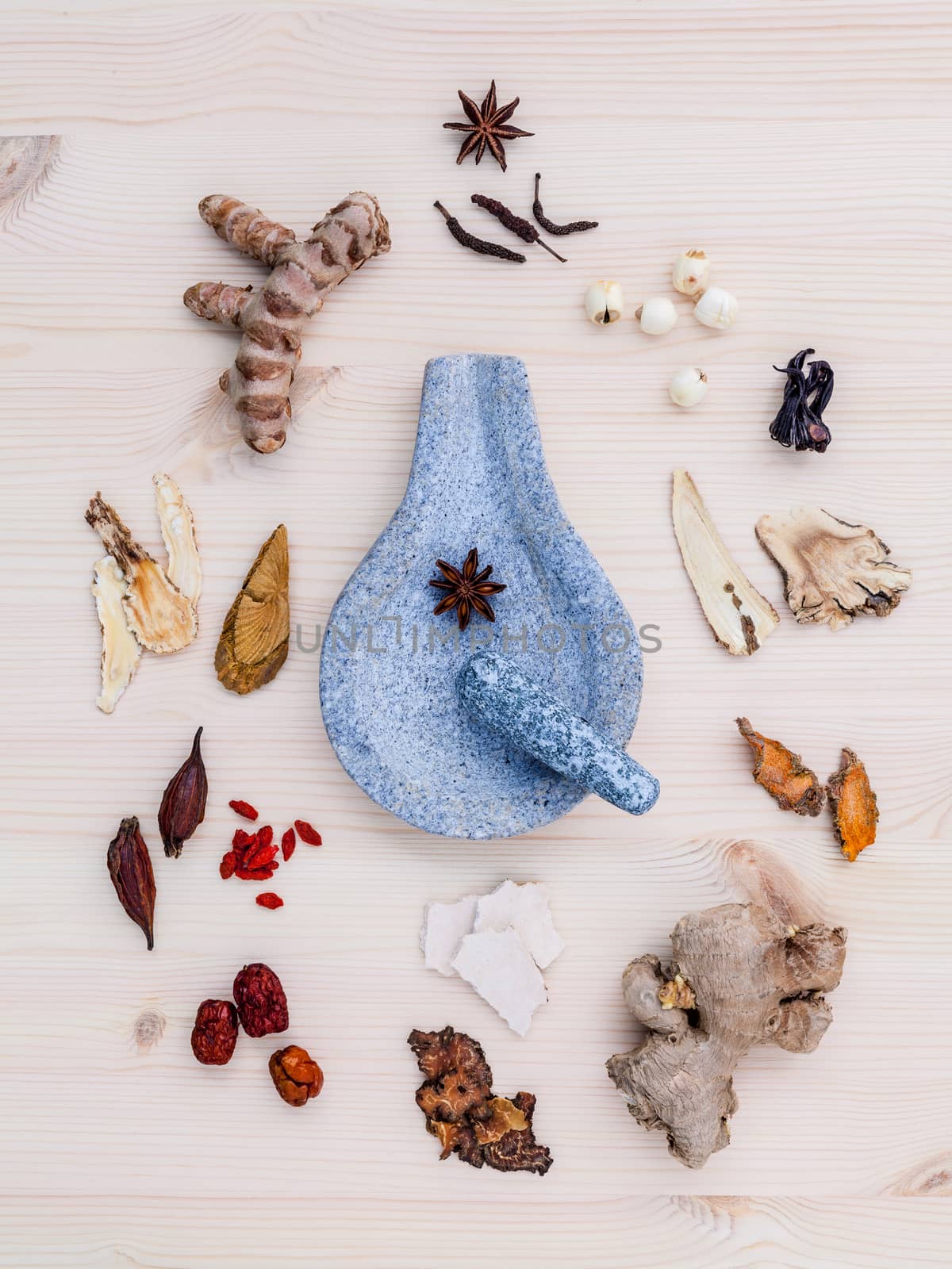 Alternative medicinal dried various Chinese herbs for healthy recipe ginseng ,goji berry ,ginger ,turmeric ,lotus seed ,star anise ,monkey apple and long pepper with mortar on wooden background.