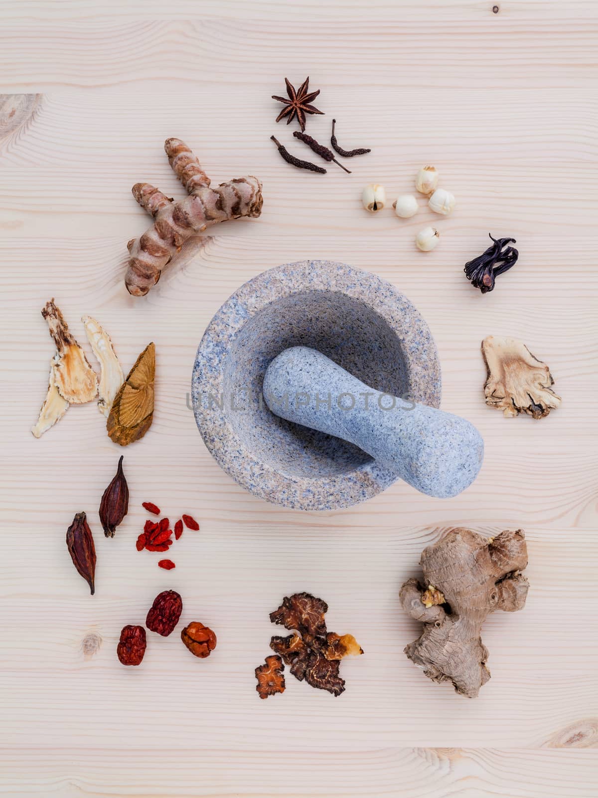 Alternative medicinal dried various Chinese herbs for healthy recipe ginseng ,goji berry ,ginger ,turmeric ,lotus seed ,star anise ,monkey apple and long pepper with mortar on wooden background.