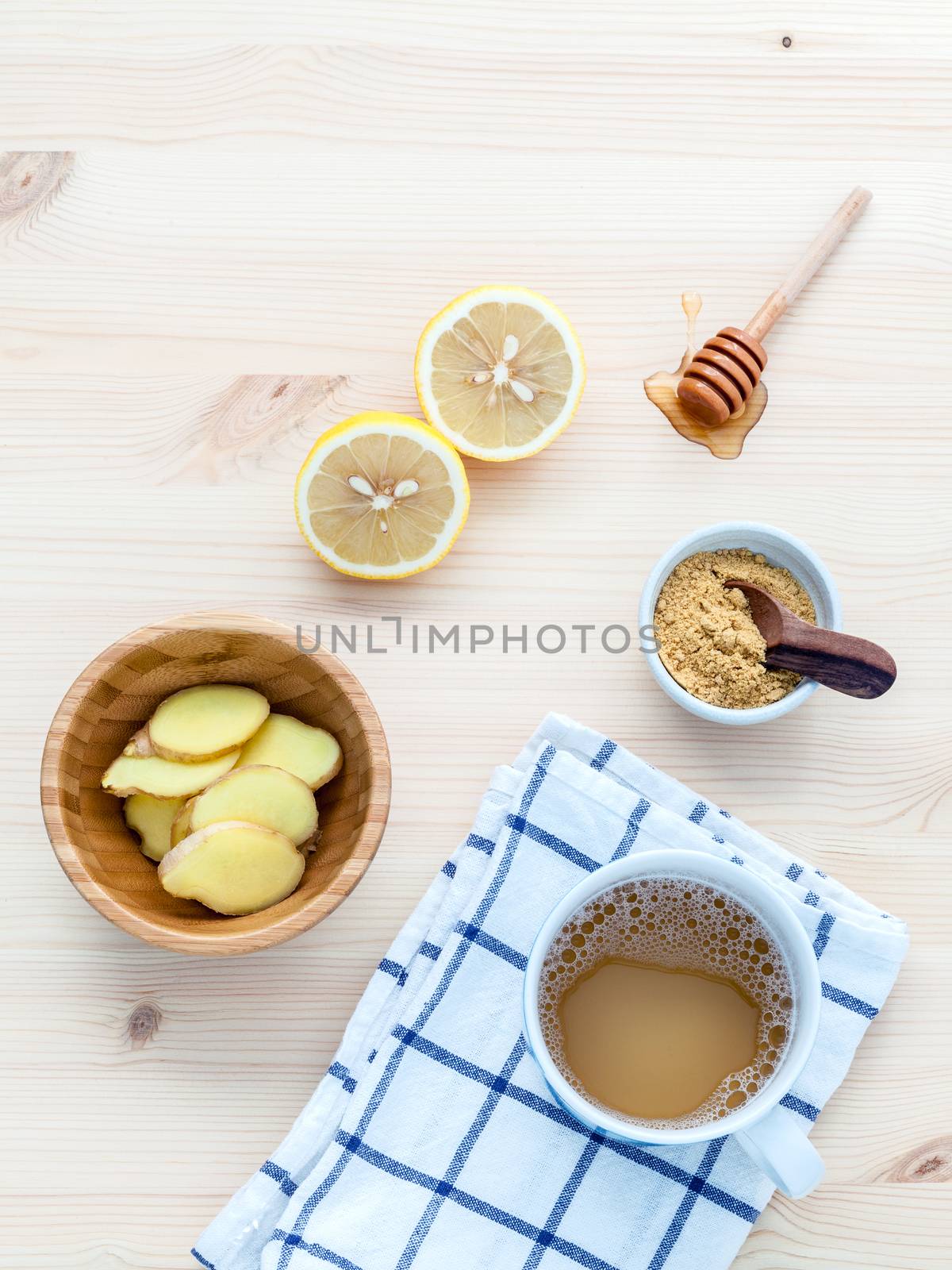 The cup of ginger tea with ginger roots , honey and mint on rustic wooden table.