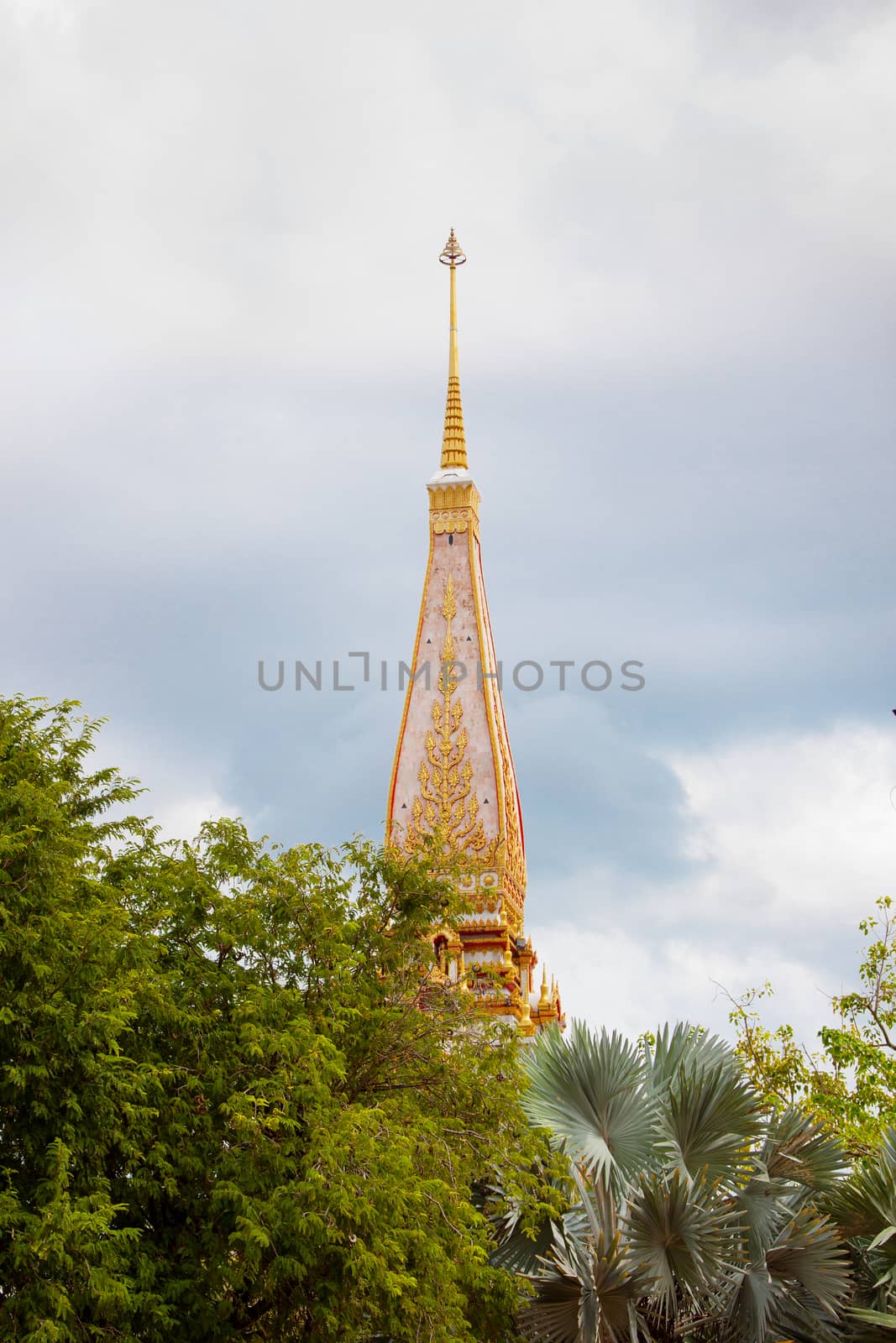 Buddhist asian gold decorated sanctuary on background of cloudy sky