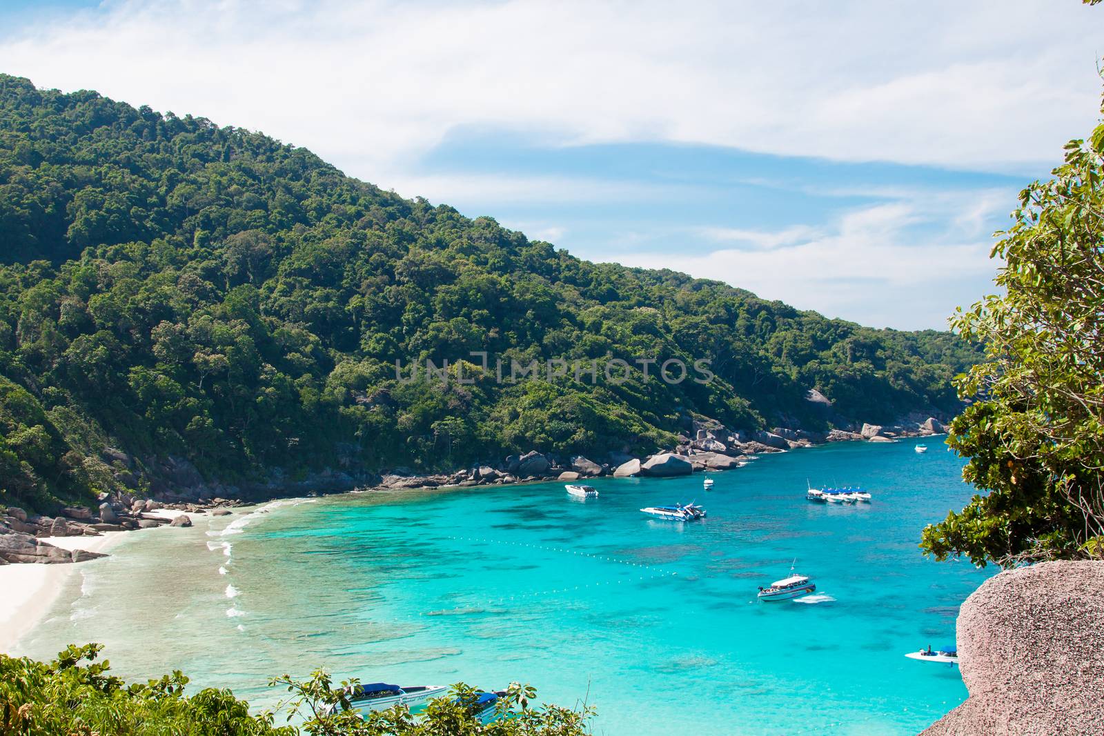 Phuket, Thailand - December 21, 2015: Beautiful view of tropical paradise beach with rocks and green exotic foliage