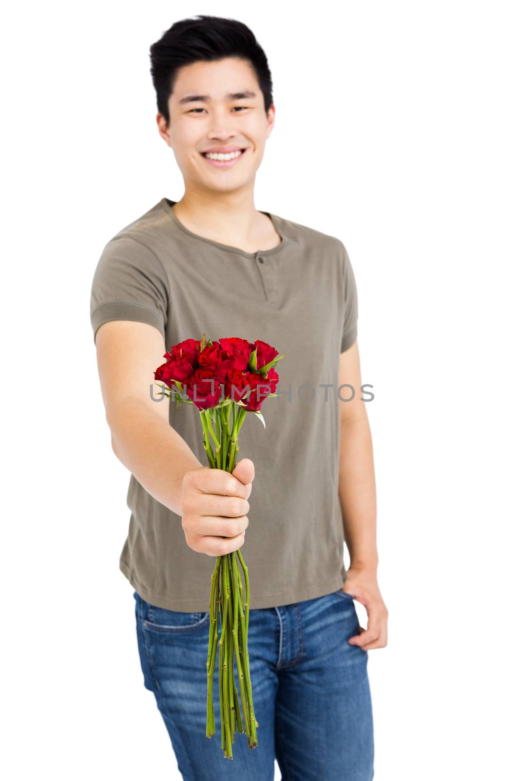 Portrait of a happy young man holding bunch of red roses on white background