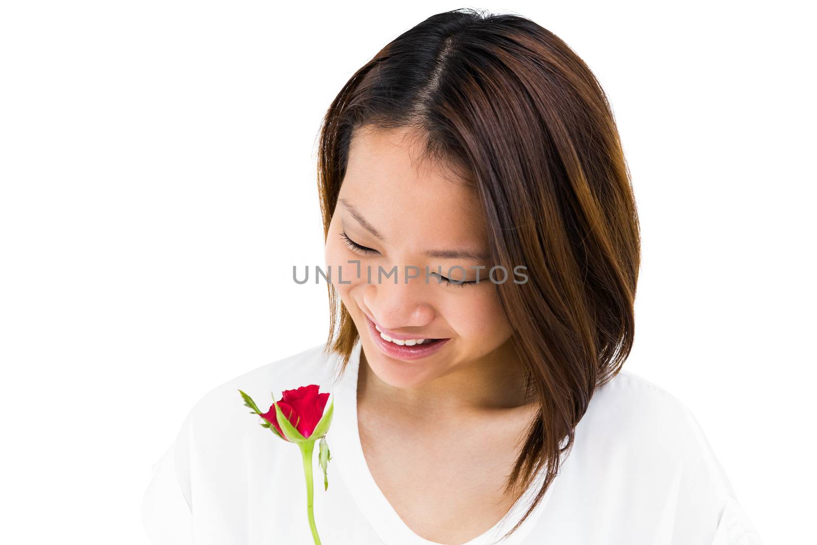 Happy woman holding red rose by Wavebreakmedia