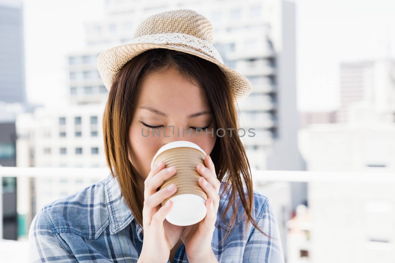 Young woman having coffee by Wavebreakmedia