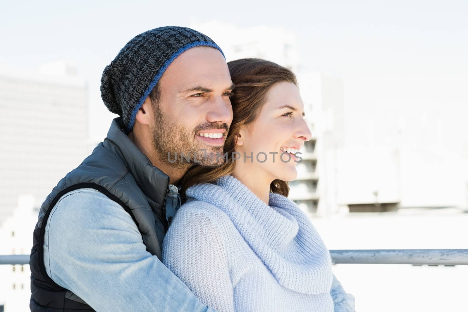 Happy young couple embracing by Wavebreakmedia