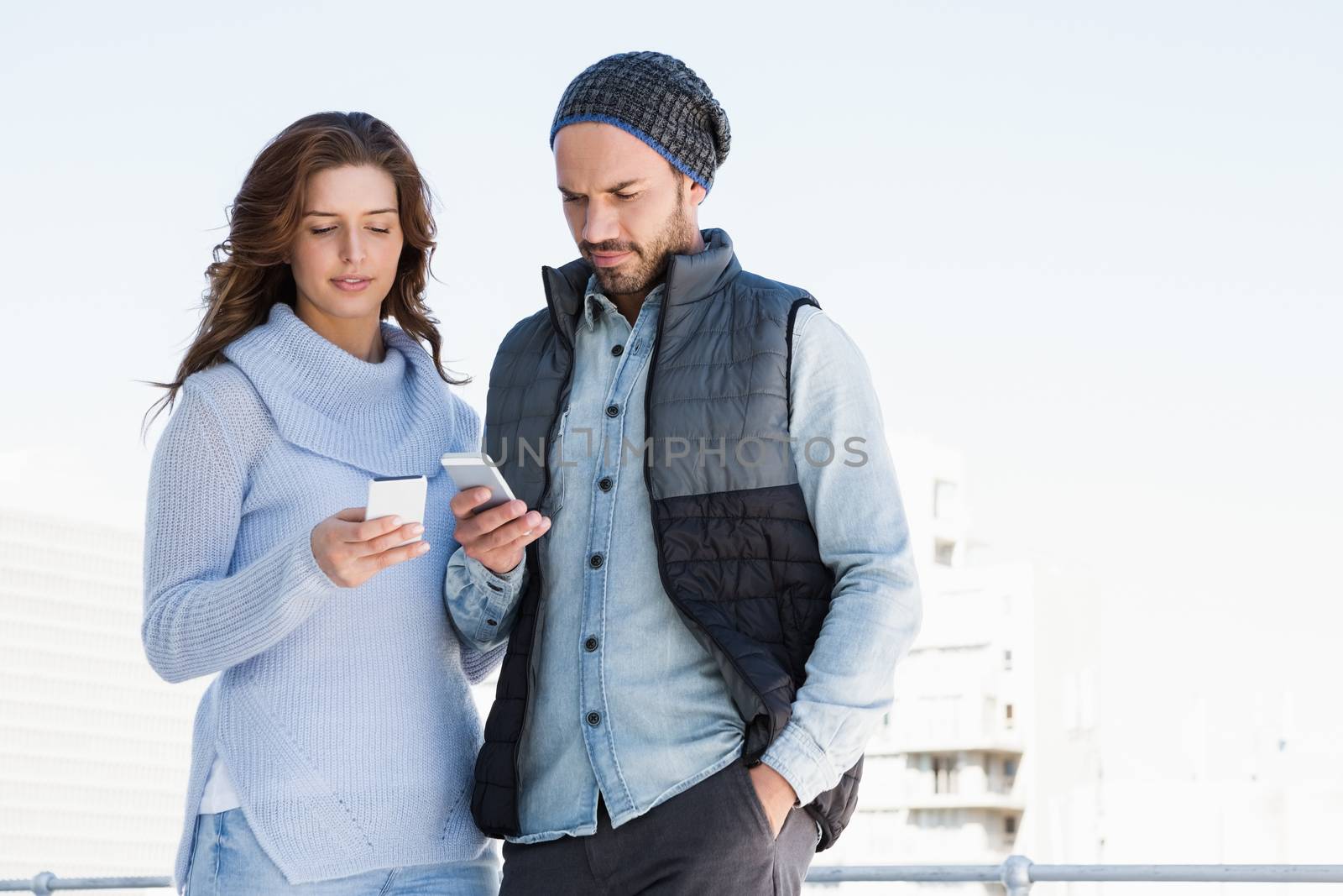 Young couple using mobile phone by Wavebreakmedia