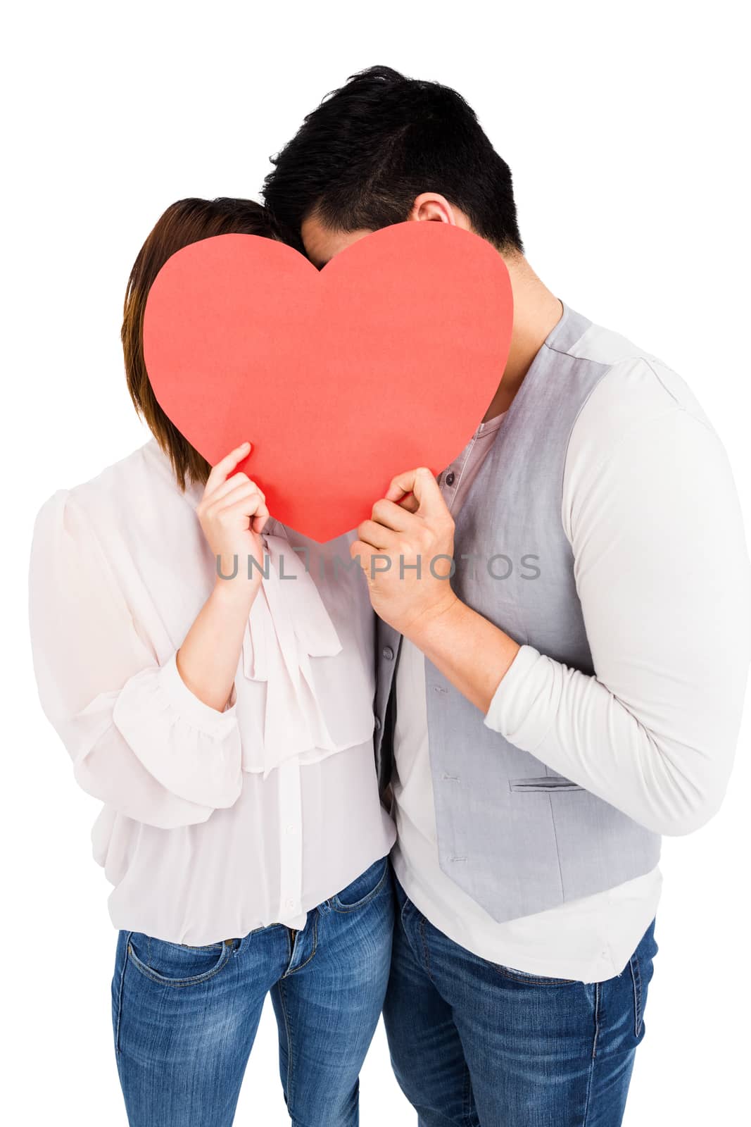 Young couple holding a heart shape on white background