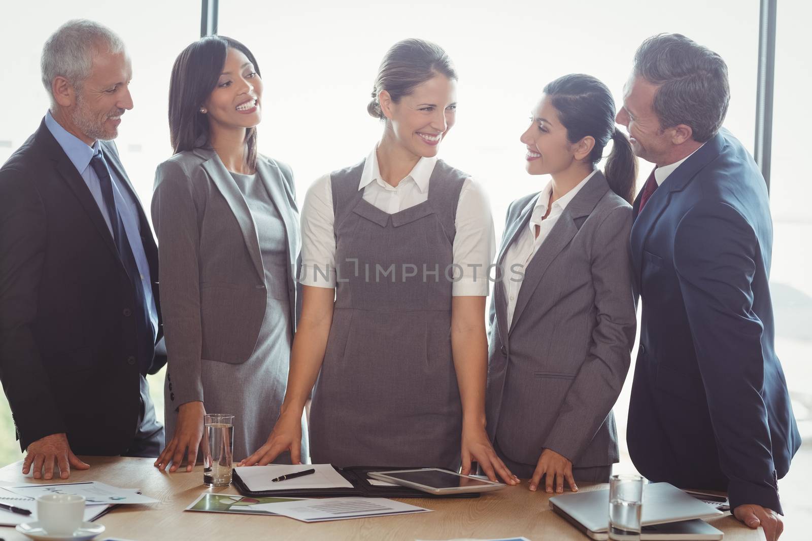 Businesspeople interacting in conference room in office