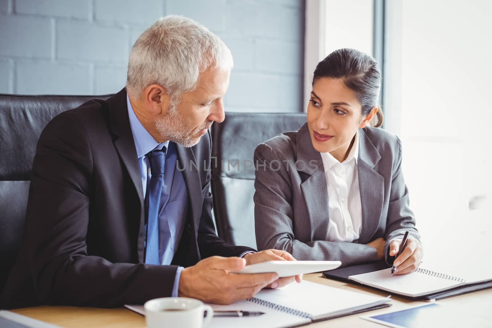 Businessman and businesswoman interacting in conference room