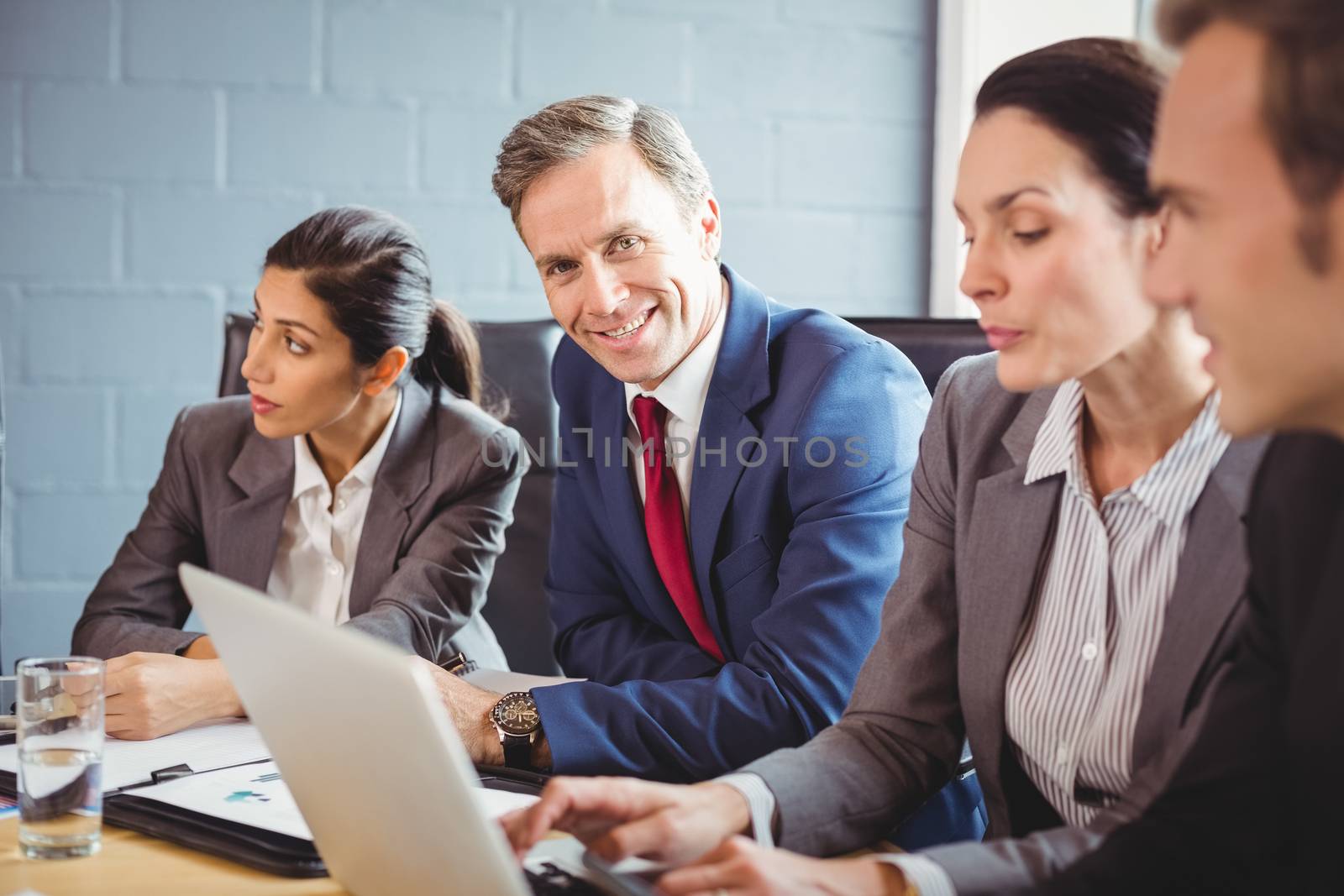 Businesspeople interacting in conference room during meeting