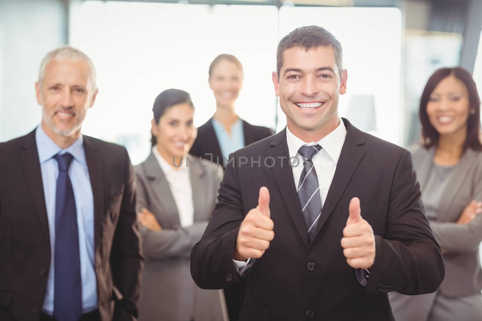 Businessman giving thumbs up by Wavebreakmedia