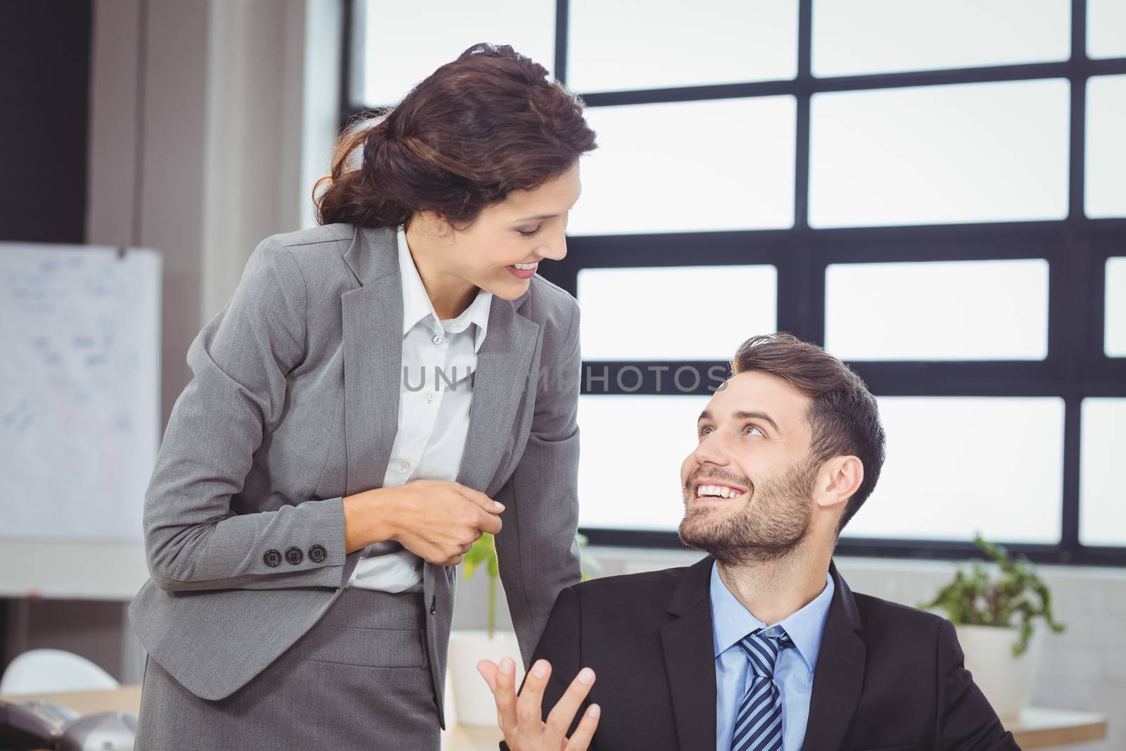 Business people smiling while talking by Wavebreakmedia