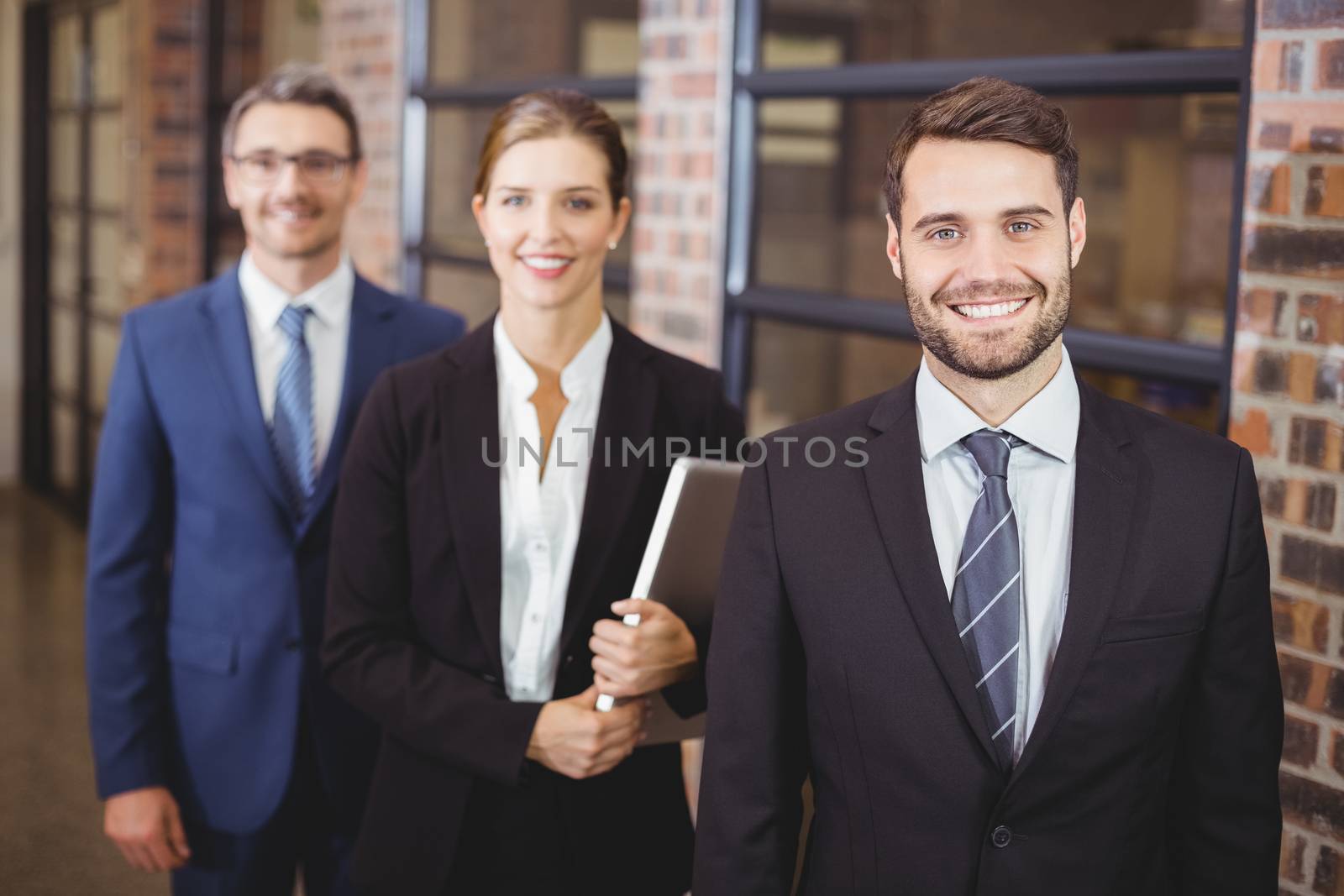 Happy business people standing in office