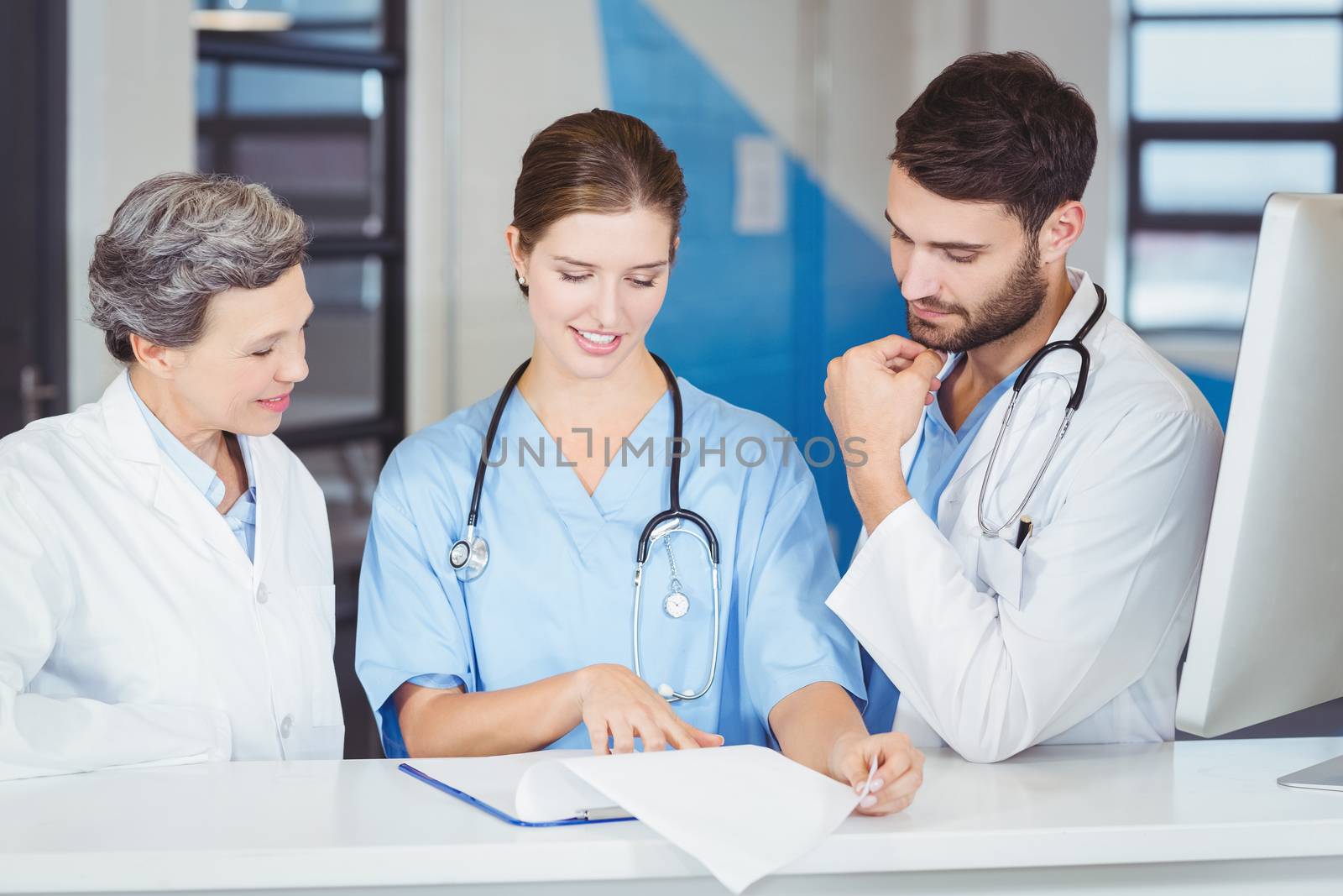 Doctor team working at computer desk in hospital