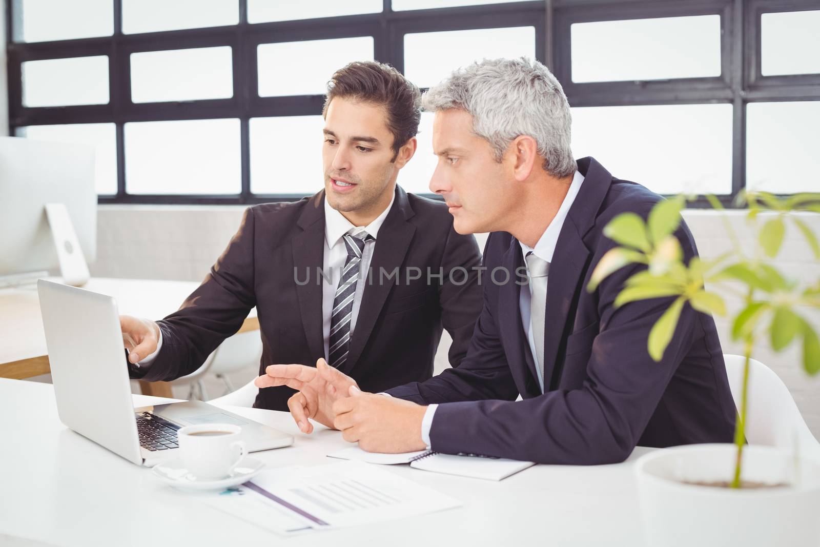 Business people working on laptop in office