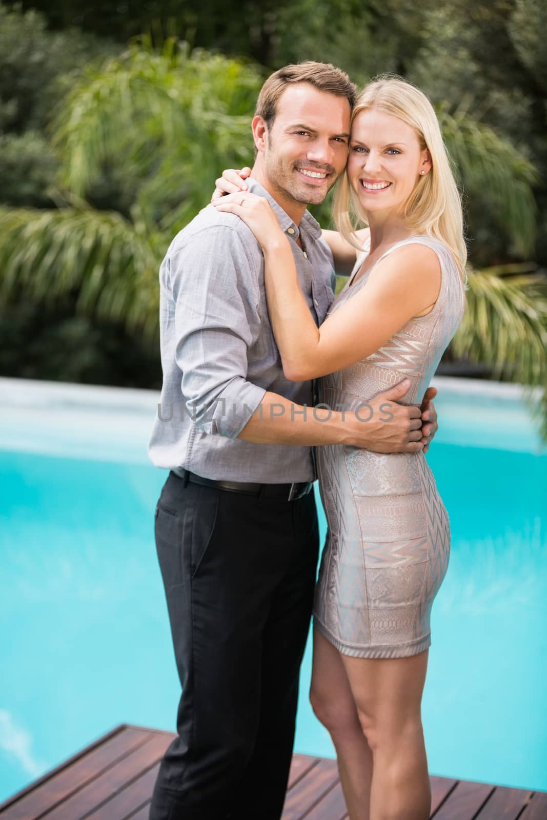 Portrait of smiling couple hugging at resort