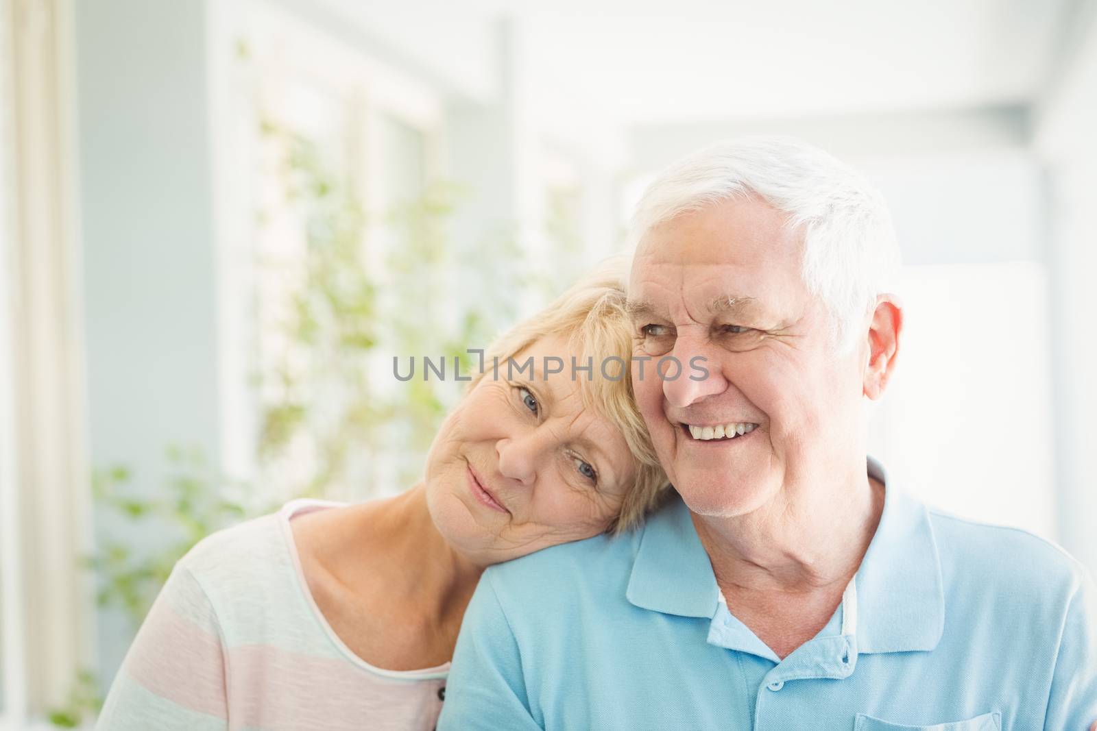 Happy romantic senior couple smiling at home