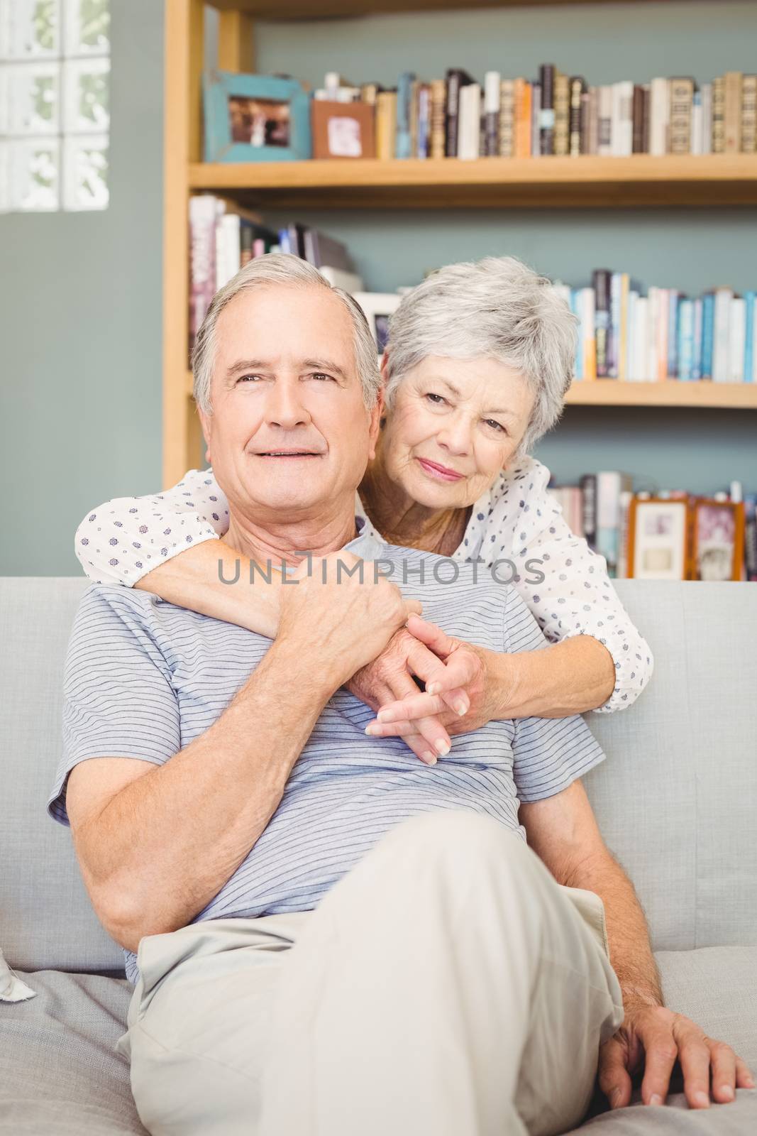 Happy romantic senior couple in living room at home