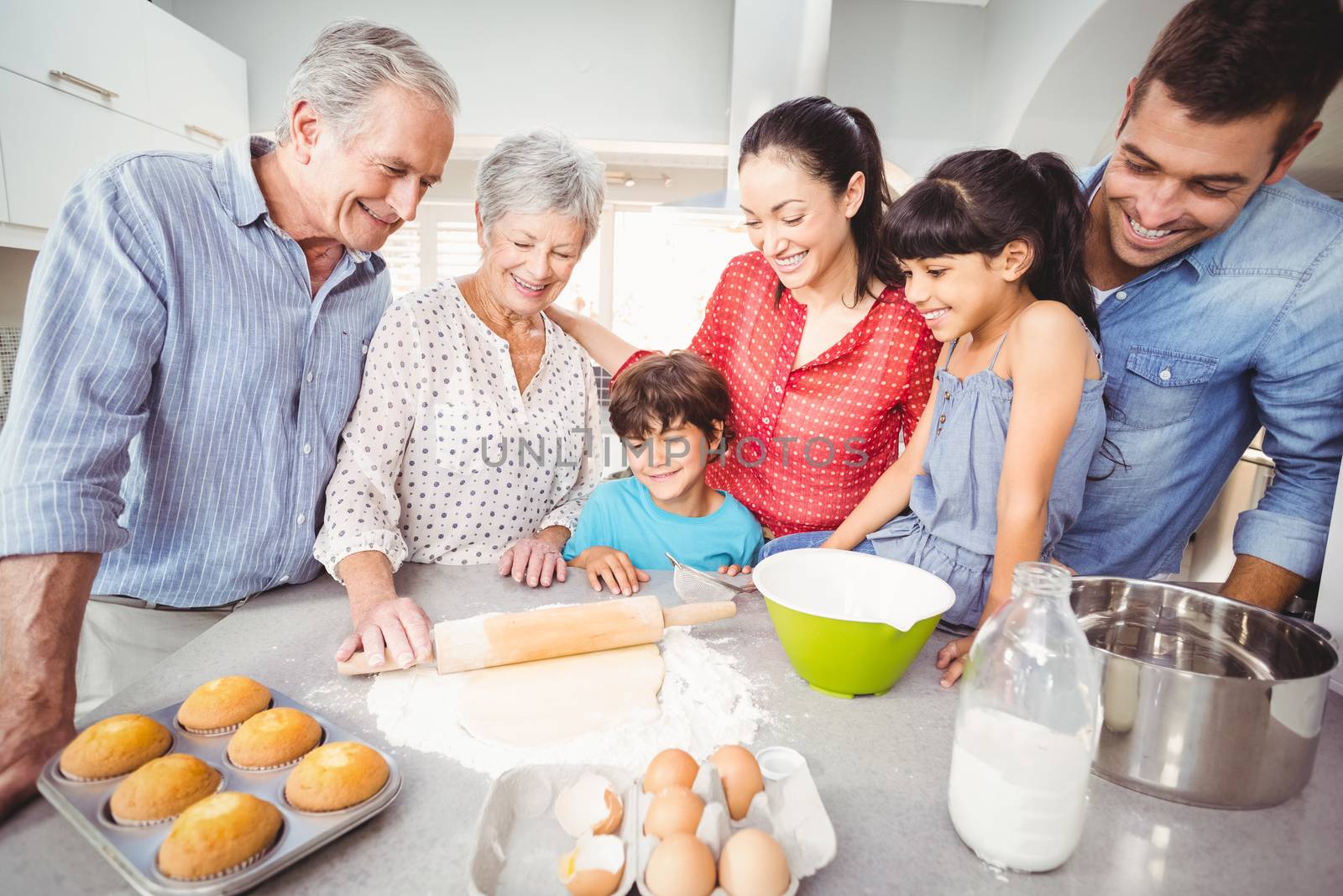 Happy family making bread in kitchen at home