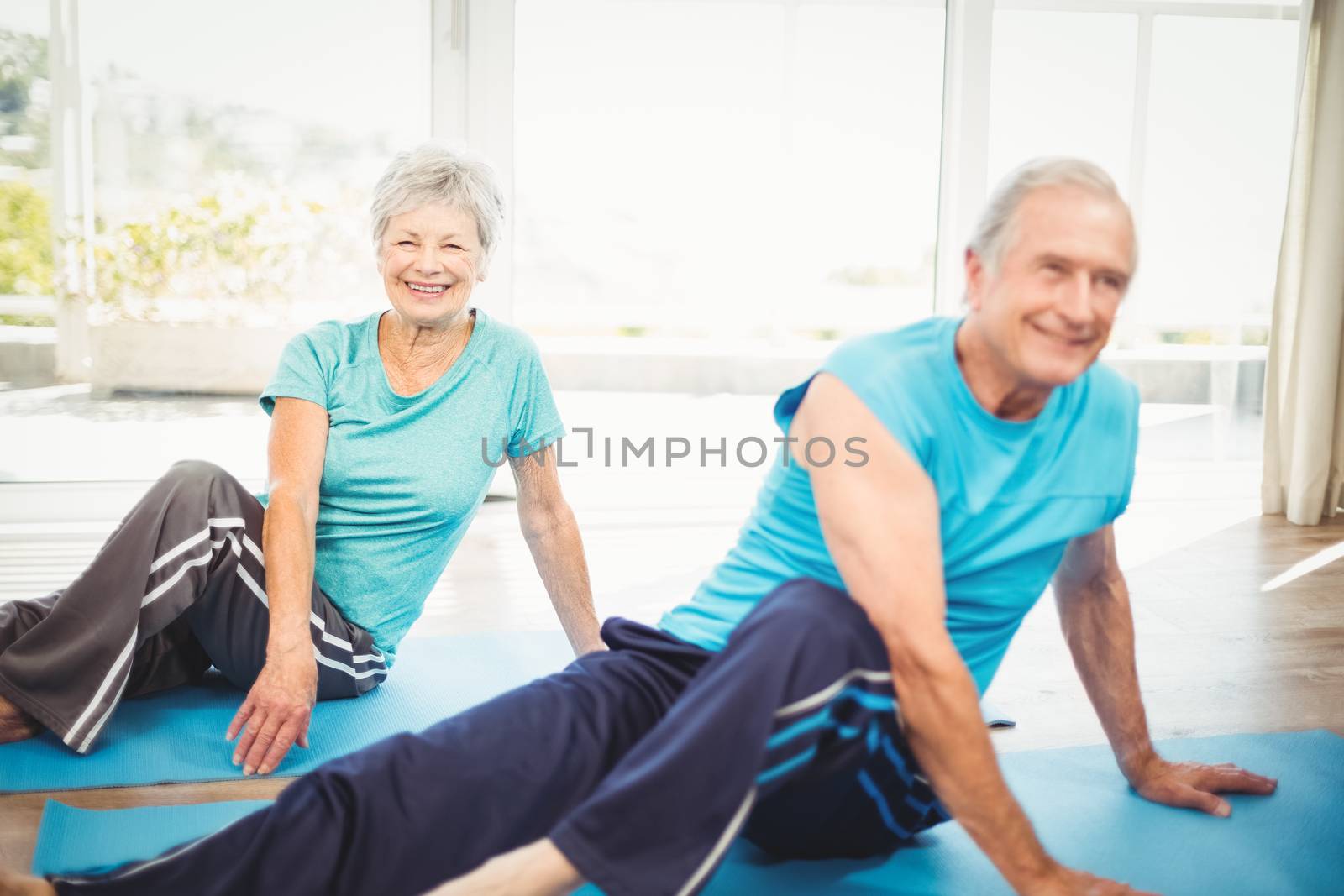 Senior couple doing yoga by Wavebreakmedia