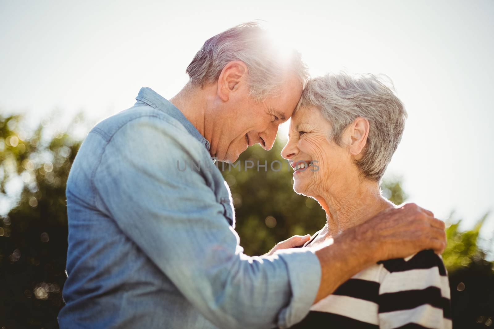 Side view of romantic senior couple looking at each other in back yard
