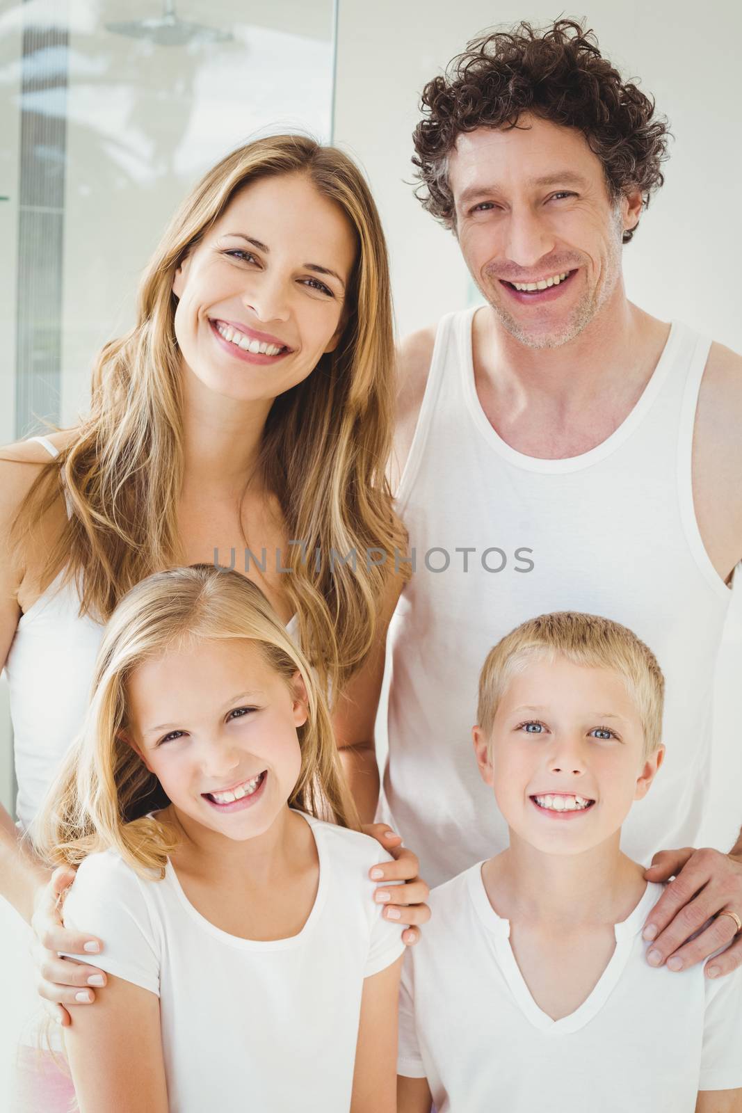 Portrait of smiling happy family standing at home