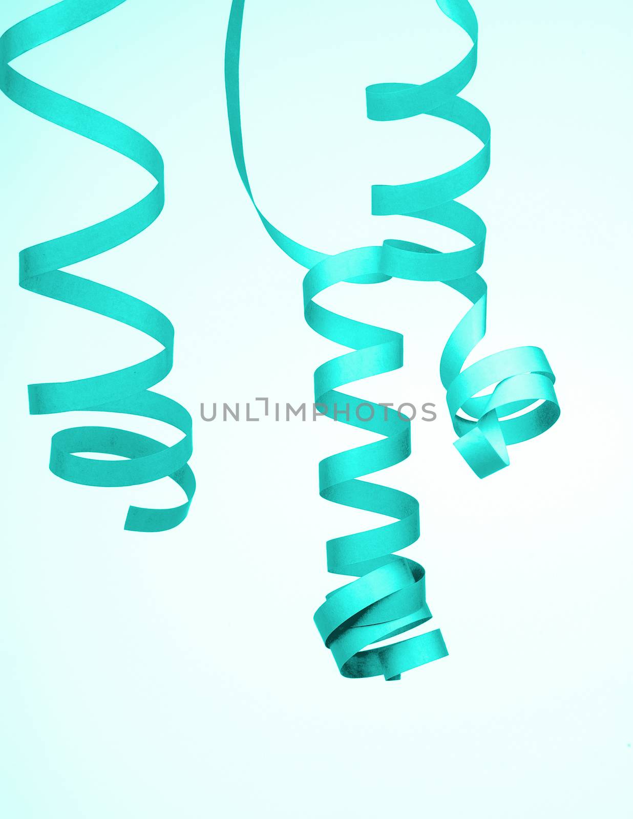 Three Turquoise Curled Party Streamers isolated on Blue-White background