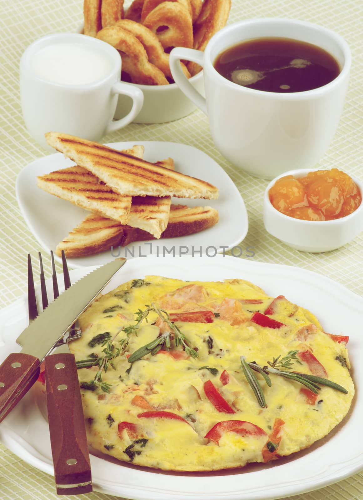 Hearty Classic Breakfast with Delicious Omelet, Toasts, Apricot Jam, Cup of Coffee, Milk and Puff Pastry closeup on Light Green Checkered background. Retro Styled