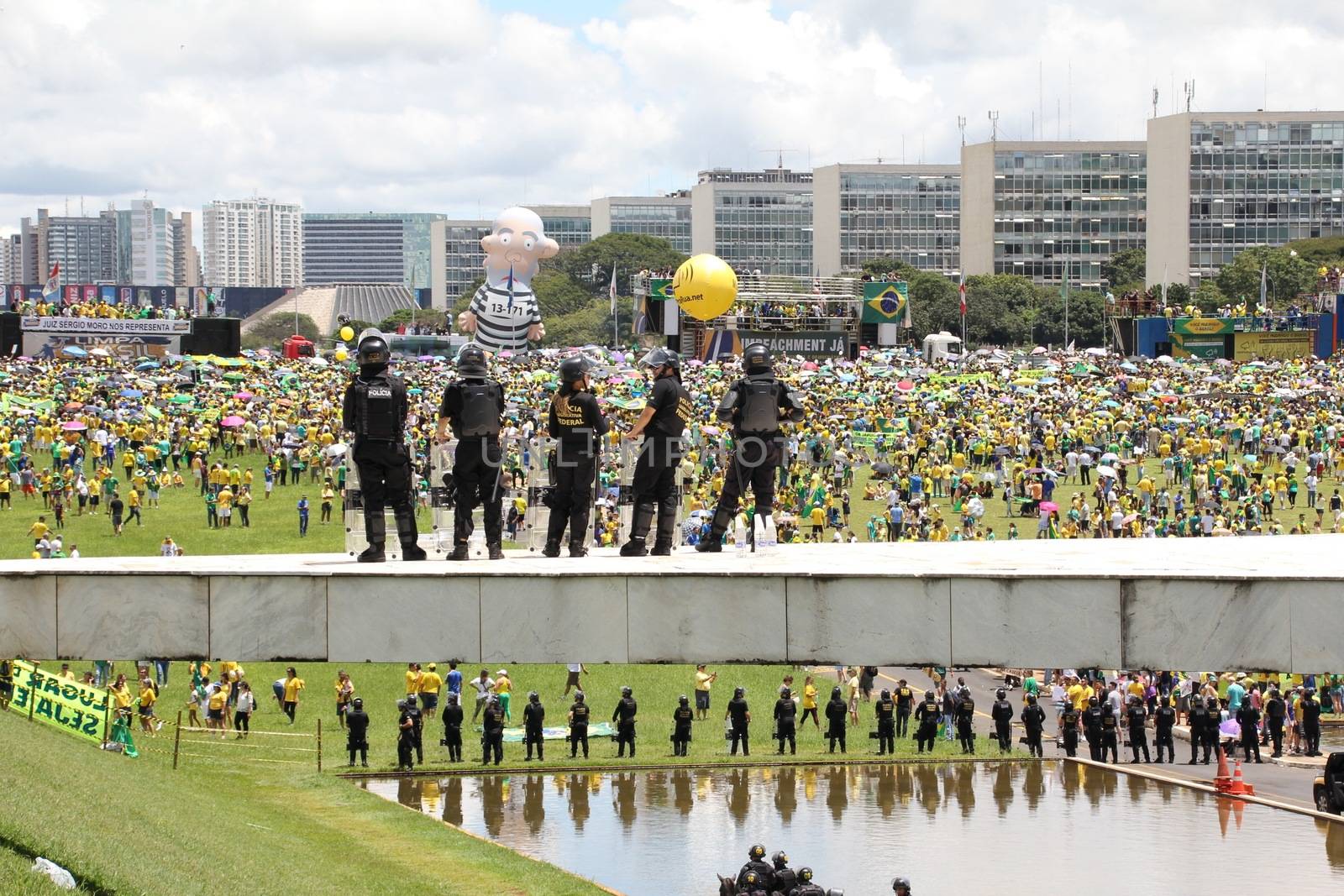 BRAZIL, Brasilia: Riot police officers stand in guard as thousands of anti-government protestors gather on the Praça dos Três Poderes (Three Powers Square), in Brasilia, during a demonstration calling for the removal of President Dilma Rousseff on March 13, 2016 . Demonstrations across the country today called for President Rousseff's exit amidst a massive corruption scandal and a deep economic recession. More than a million Brazilians have joined anti-government rallies across the country, ramping up the pressure on embattled president.