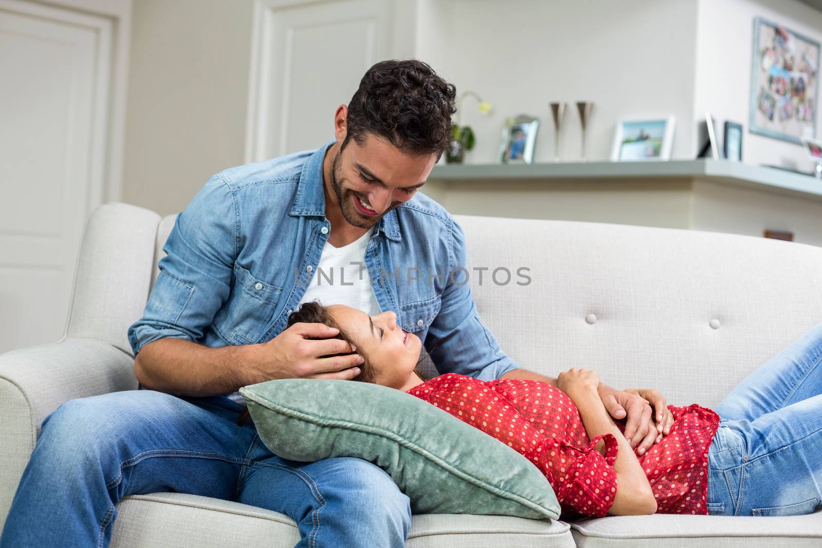 Romantic couple relaxing on sofa at home