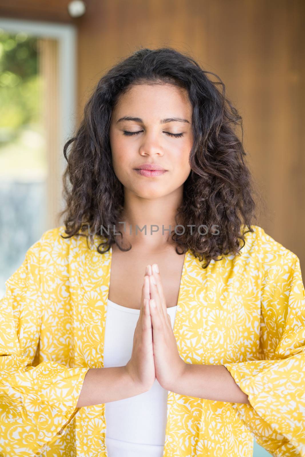 Young woman practicing yoga in lotus position 