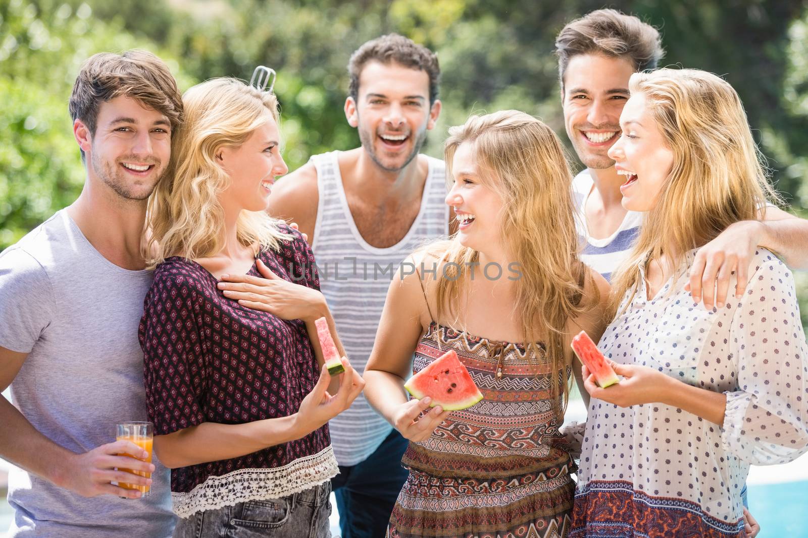 Group of friends having fun while eating a slice of water melon