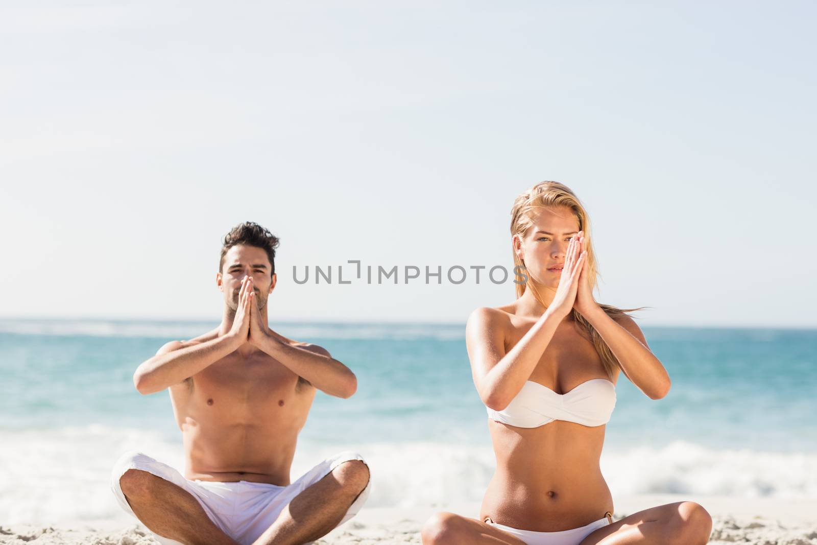 Happy couple doing yoga  by Wavebreakmedia
