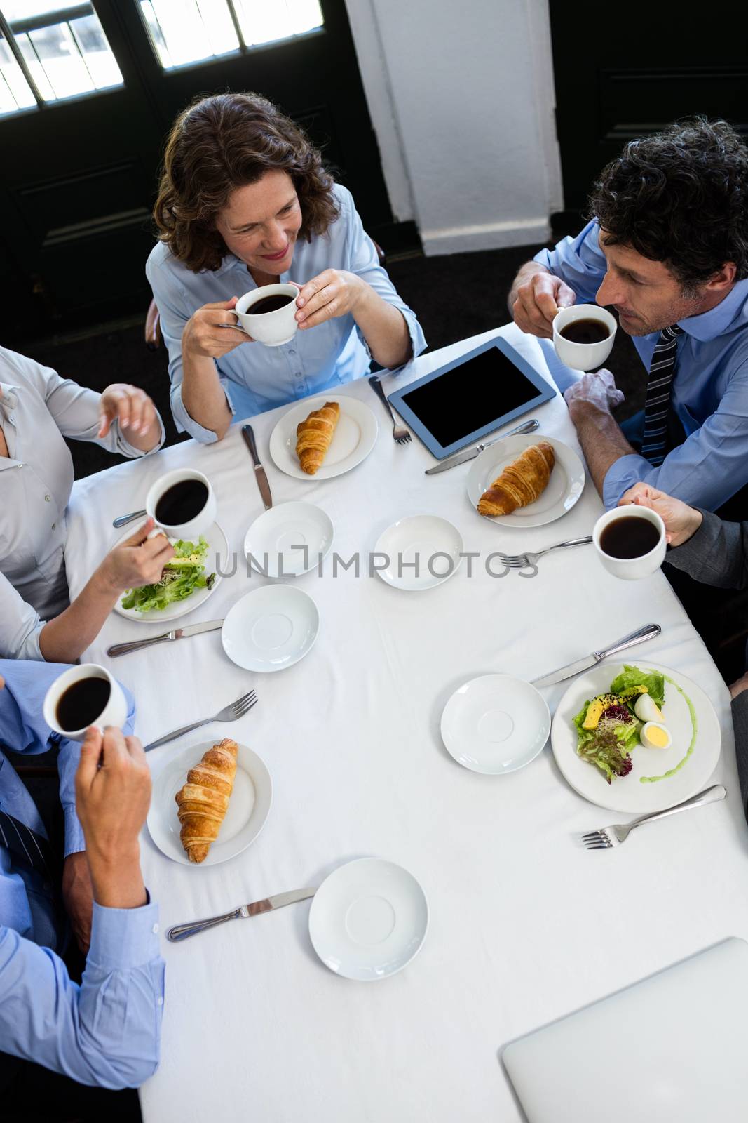 Business people having a meeting in restaurant by Wavebreakmedia