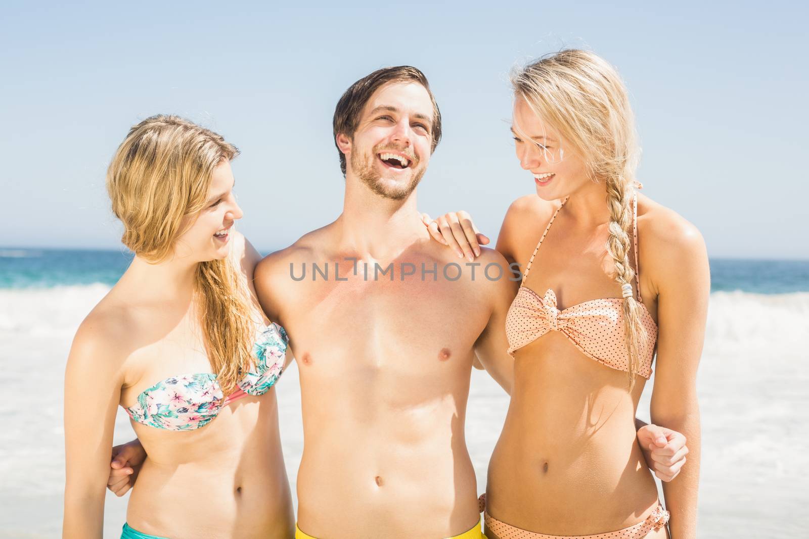 Young friends having fun on the beach by Wavebreakmedia
