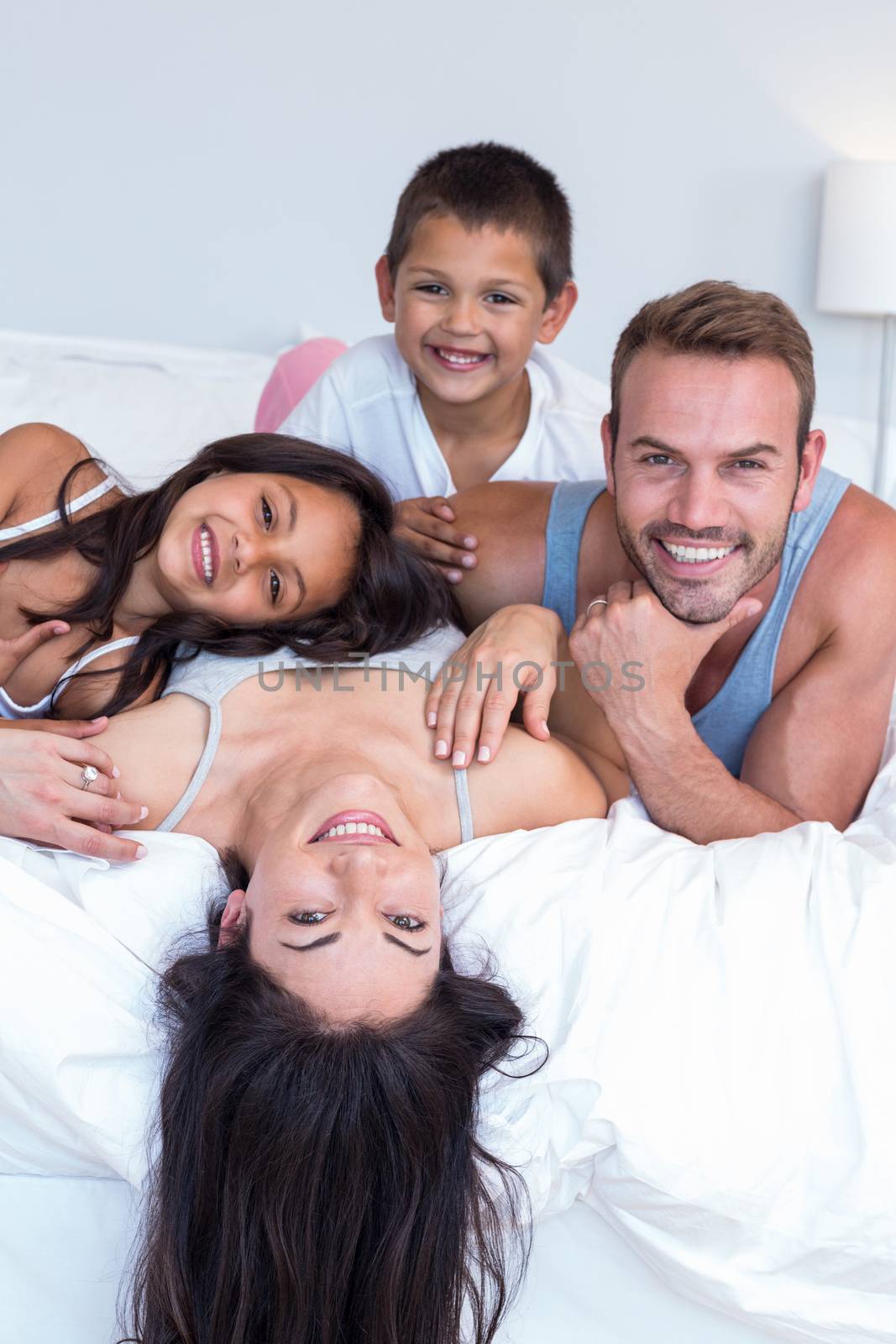 Happy family in their bedroom by Wavebreakmedia