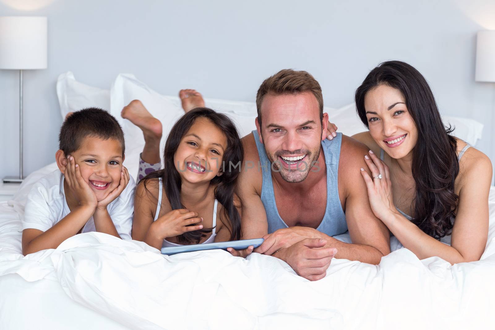 Happy family in their bedroom at home