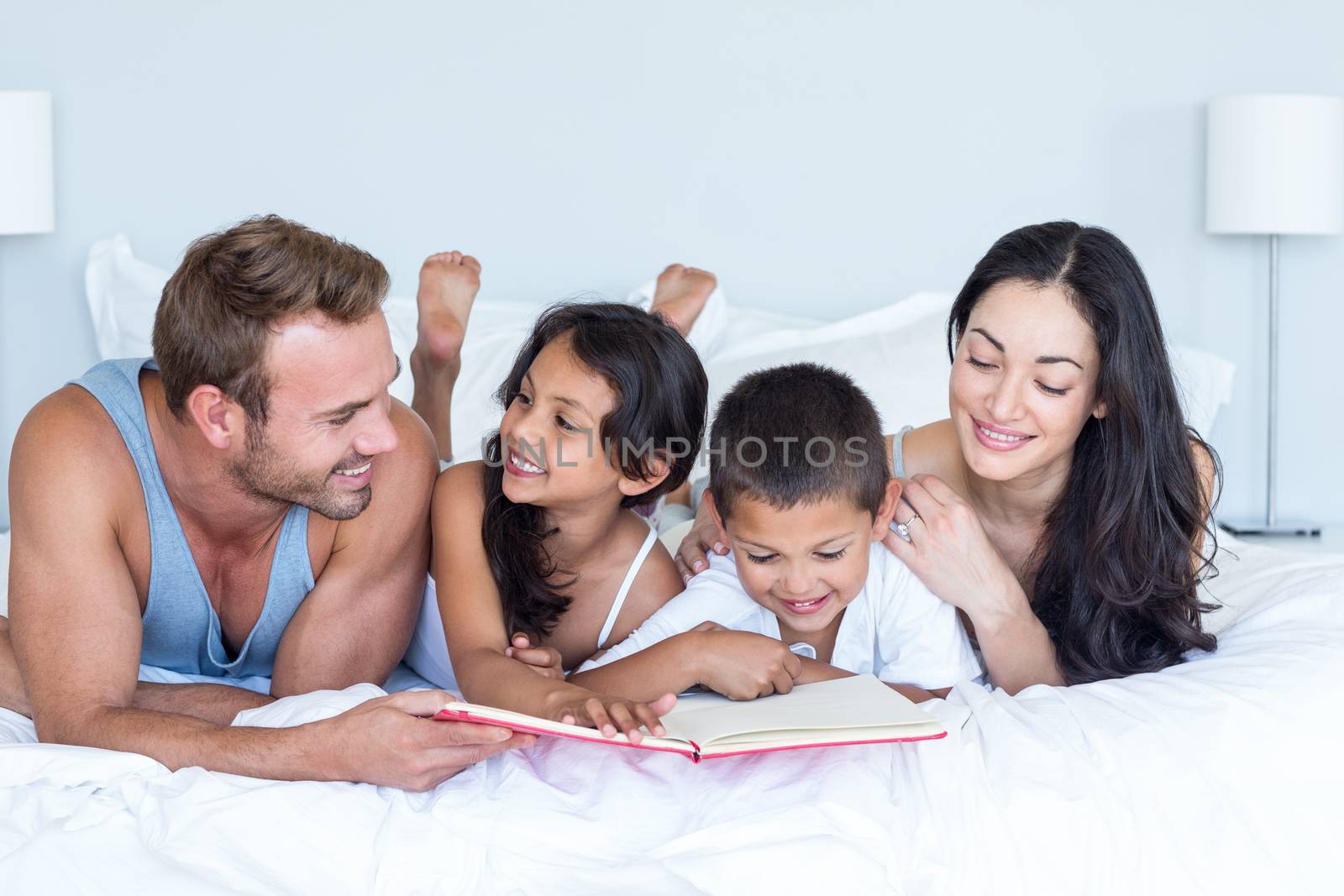 Happy family in their bedroom at home