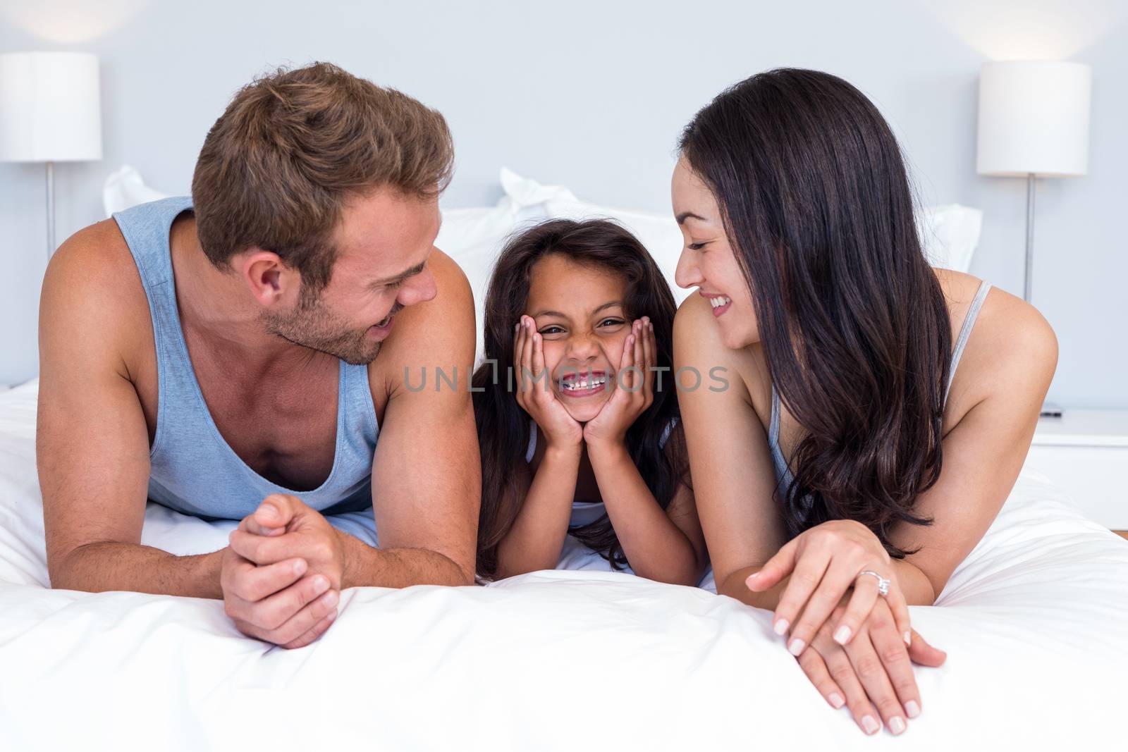 Happy family in their bedroom by Wavebreakmedia