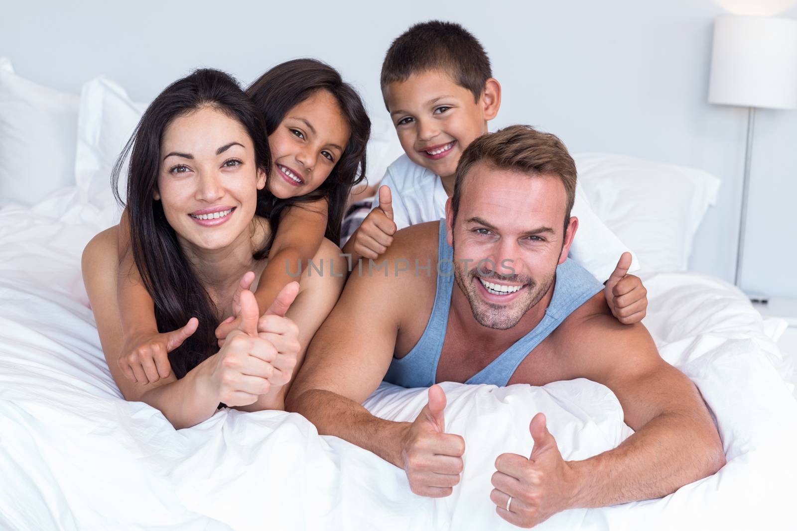 Happy family in their bedroom at home