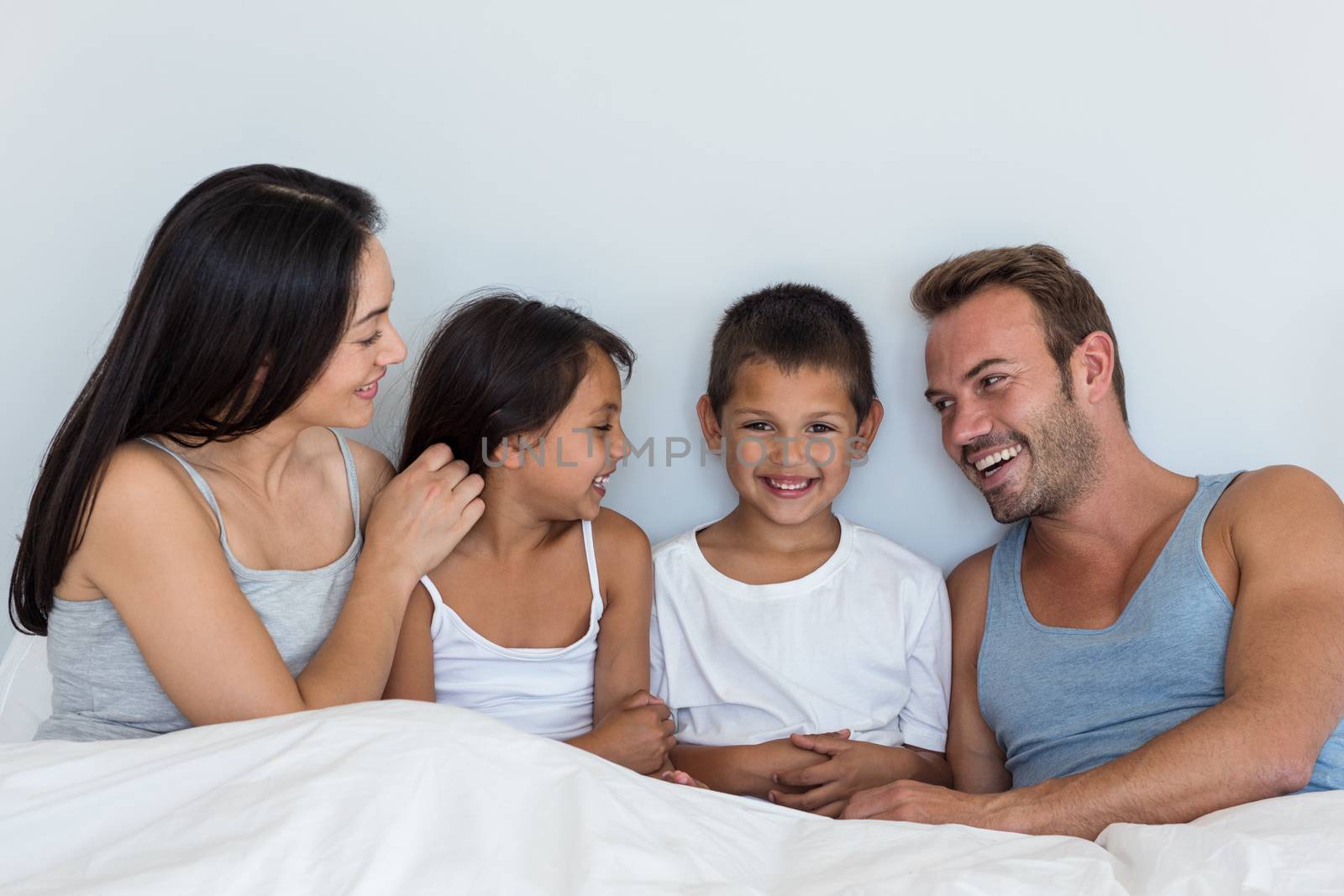 Happy family in their bedroom at home