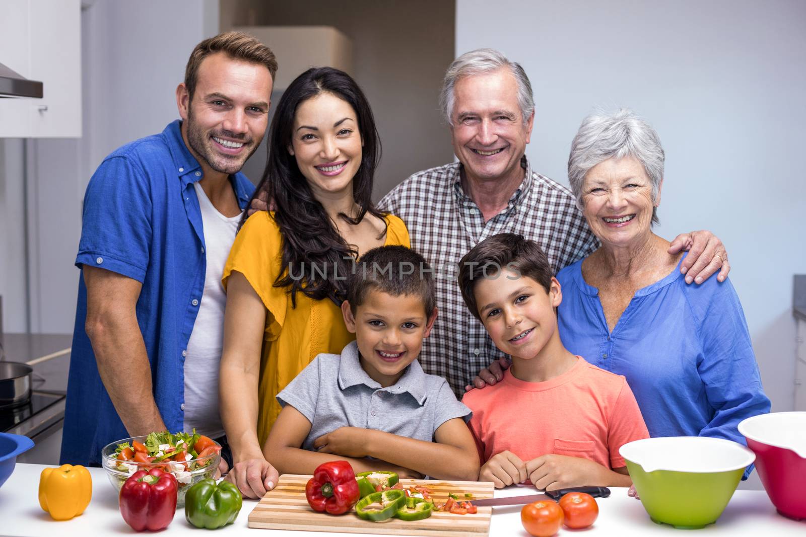 Portrait of happy family standing in the kitchen at home