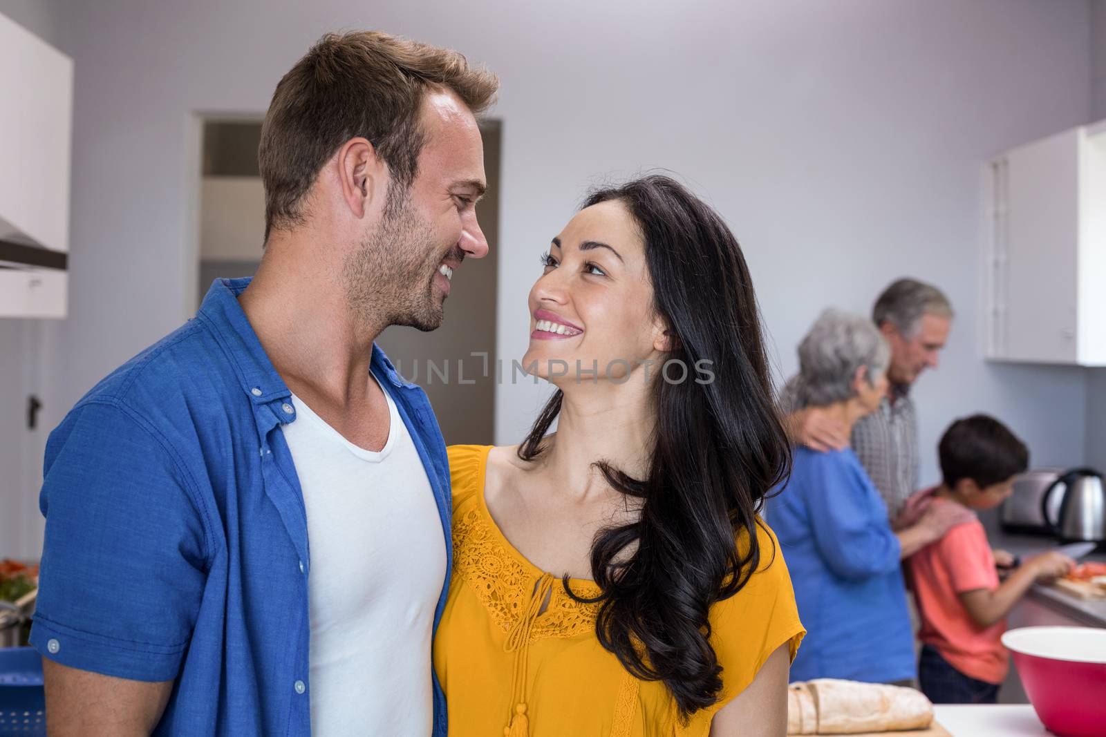 Young man and young woman standing in kitchen by Wavebreakmedia