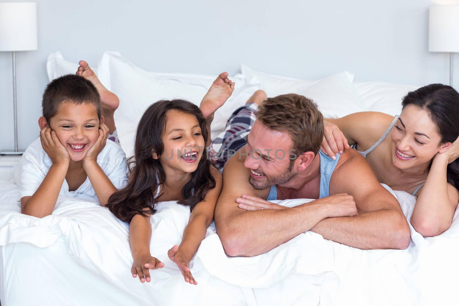 Happy family in their bedroom at home