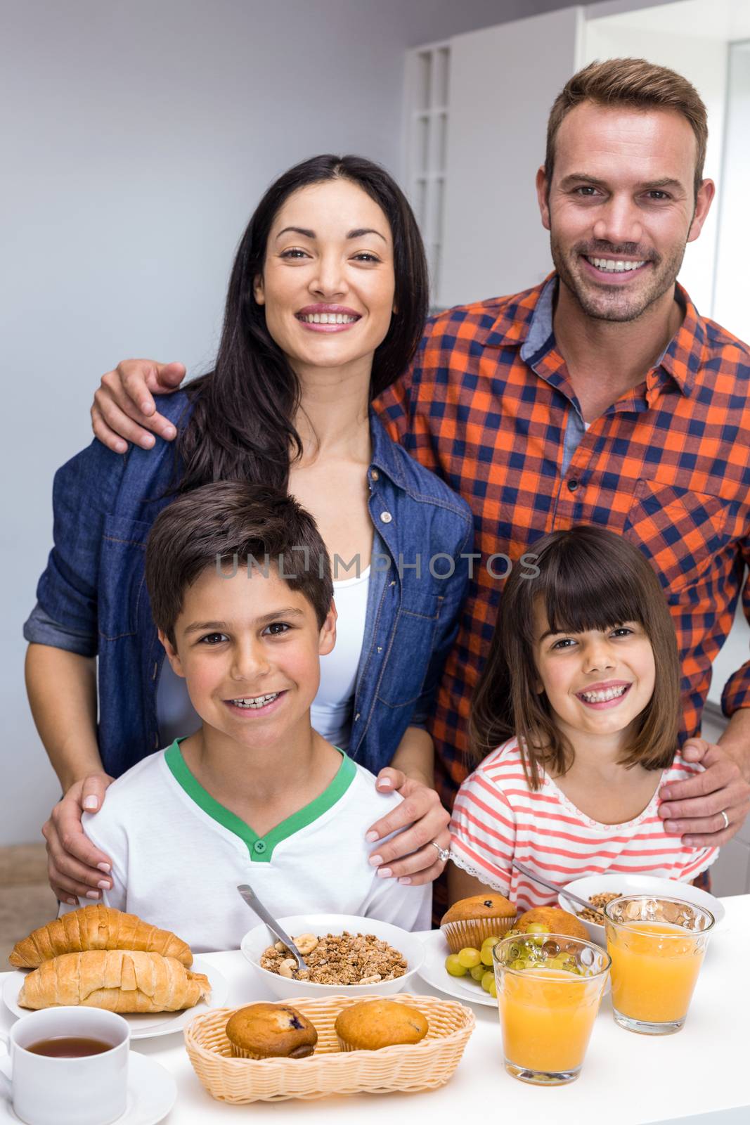 Happy family in the kitchen having breakfast