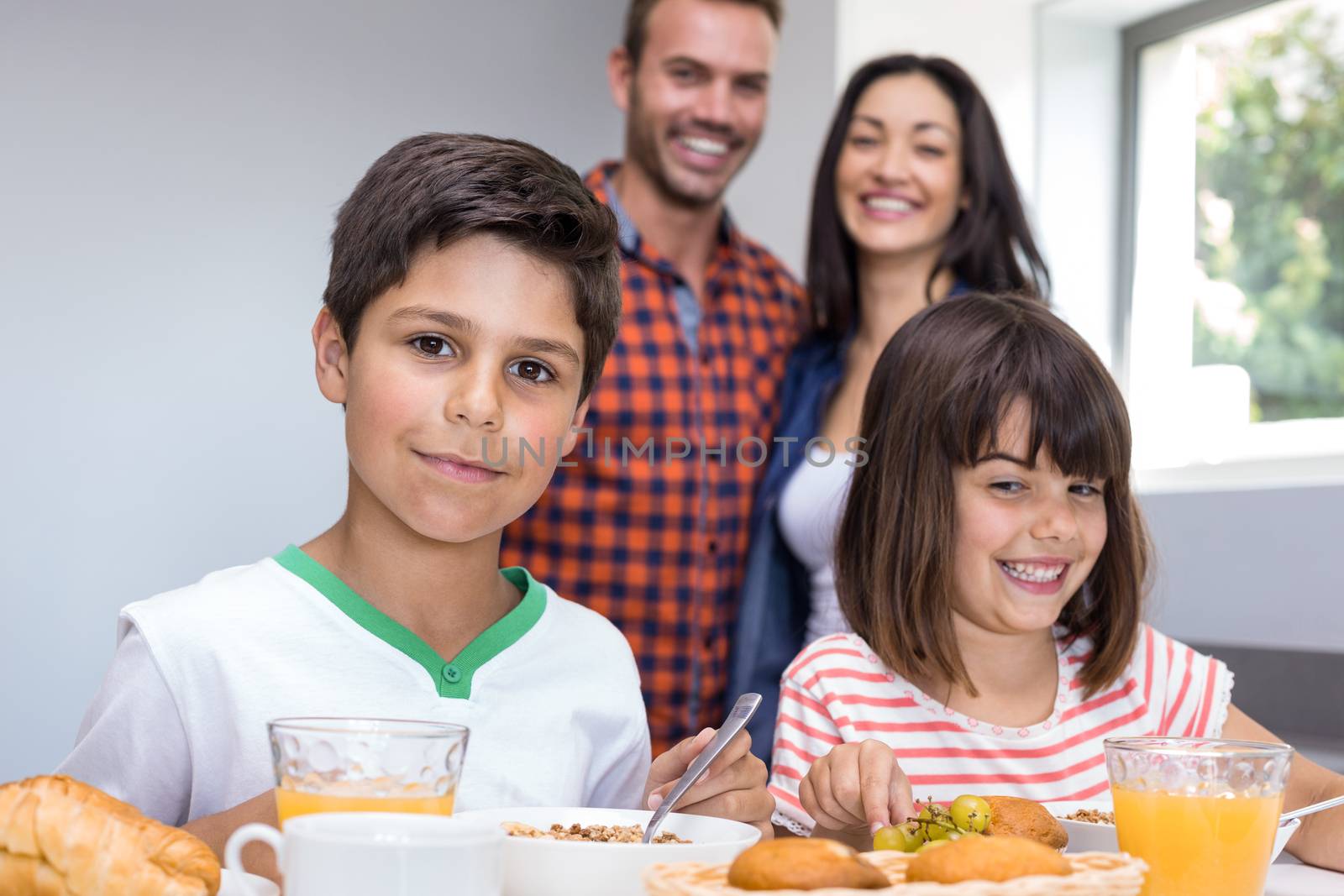 Happy family in the kitchen having breakfast